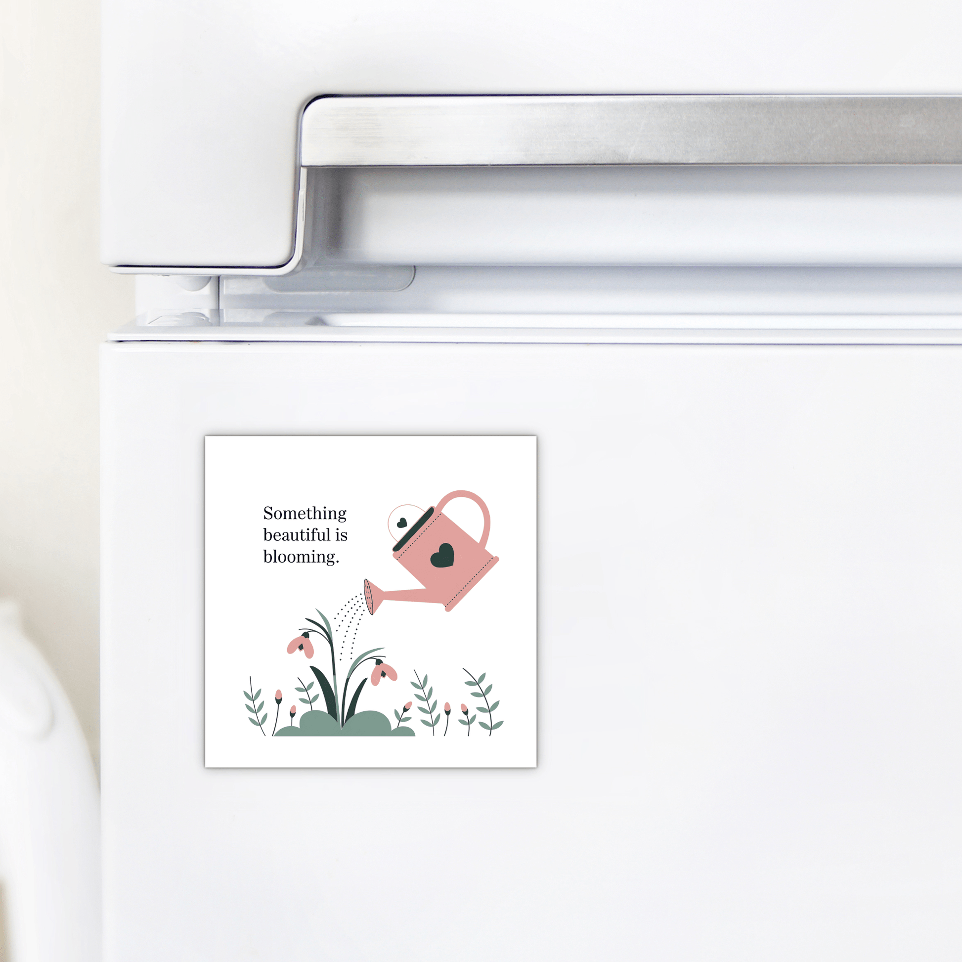 The “Something Beautiful Is Blooming Magnet” by Mirabilia Boutique features a pink watering can with flowers and a heart—an uplifting, growth-inspired fridge decor perfect as a mental health reminder or self-care gift.