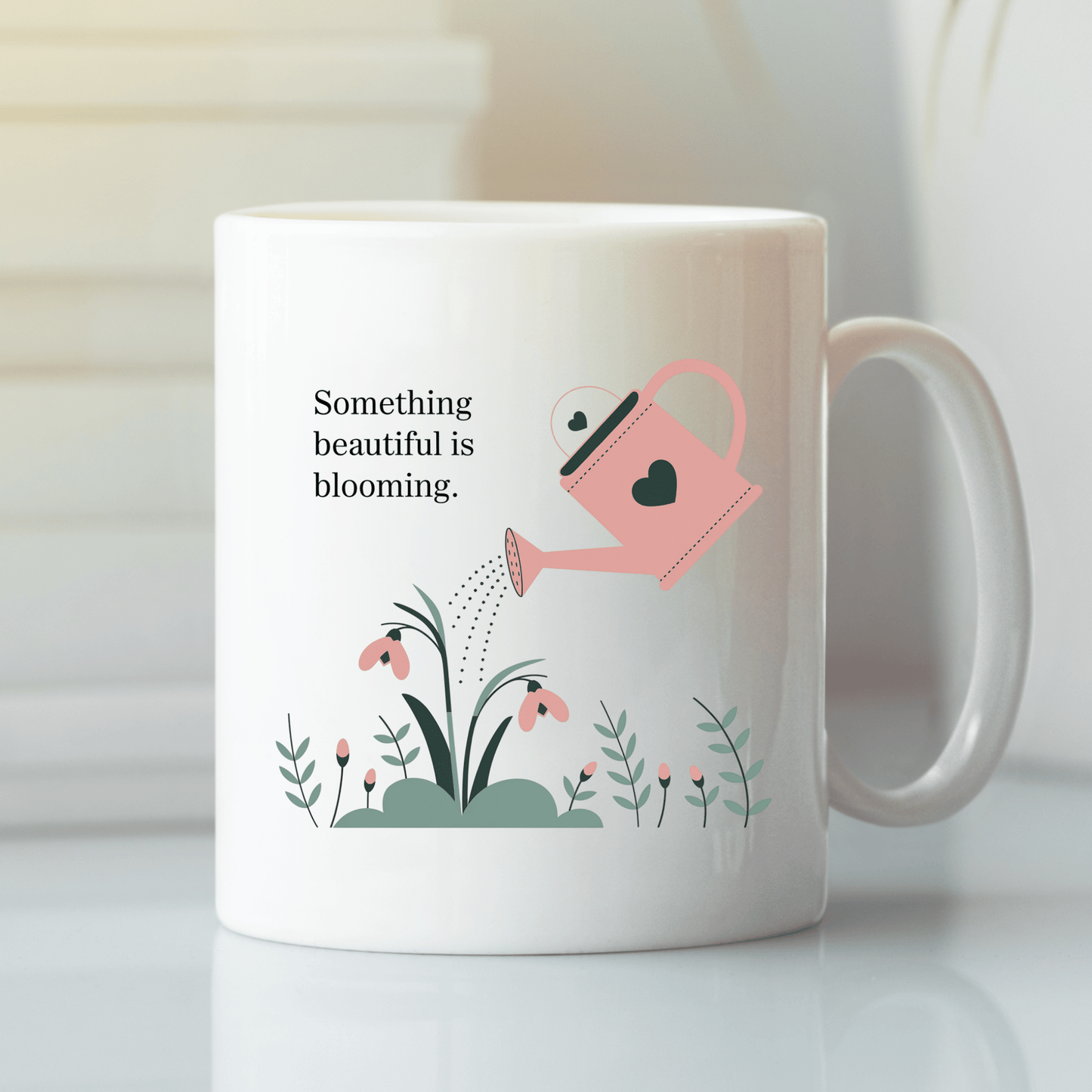 The Mirabilia Boutique "Something Beautiful Is Blooming" Mug features a pink watering can with blooming flowers and the quote, making it the perfect growth and positivity gift for self-care moments.