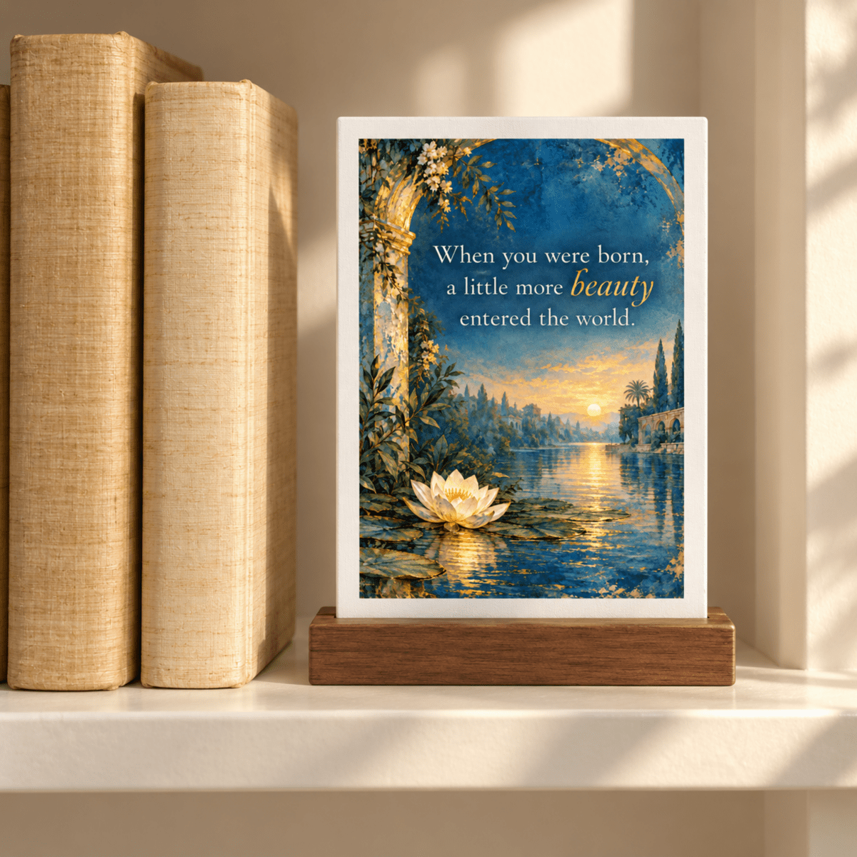 A Little More Beauty Friendship Mini Sign in a wooden stand, reading “When you were born, a little more beauty entered the world,” displayed next to two books.
