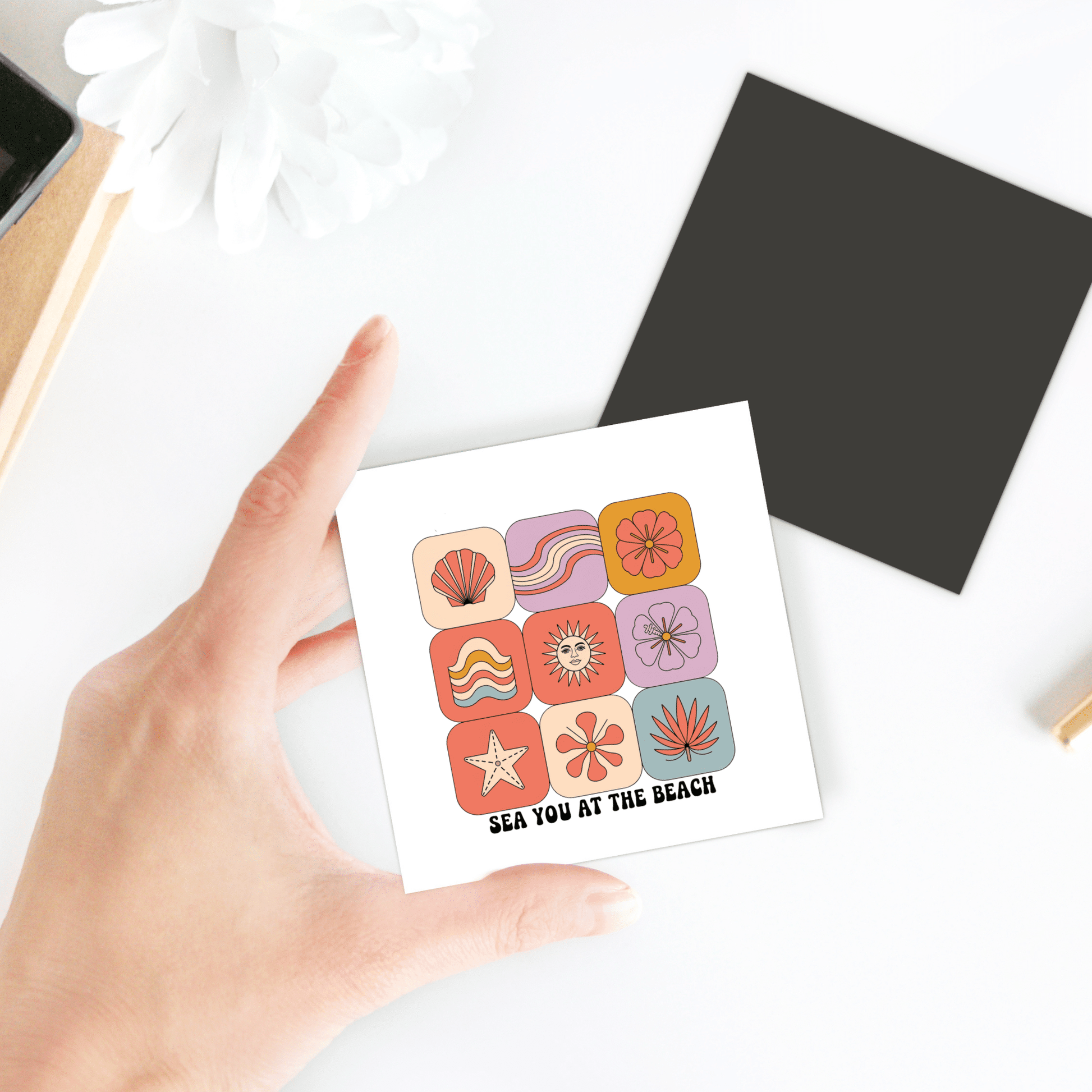 A hand holds the Sea You at the Beach Magnet – Retro Summer Vibes by Mirabilia Boutique, a colorful retro-style magnet perfect for adding coastal decor charm to any space.