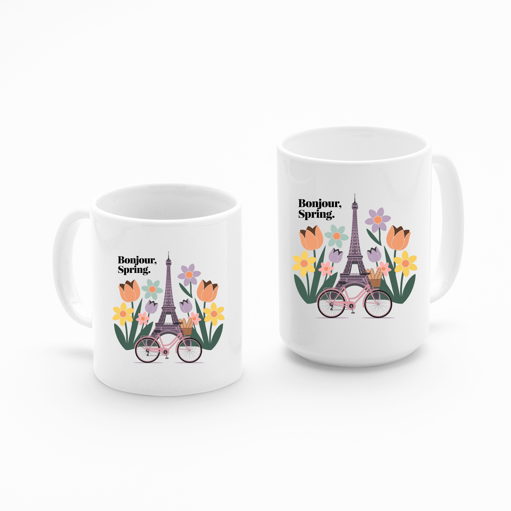 Set of two white Bonjour Spring Paris Mugs by Mirabilia Boutique, each featuring a vibrant Eiffel Tower, tulips, daisies, a bicycle, and "Bonjour. Spring." text above the floral design.