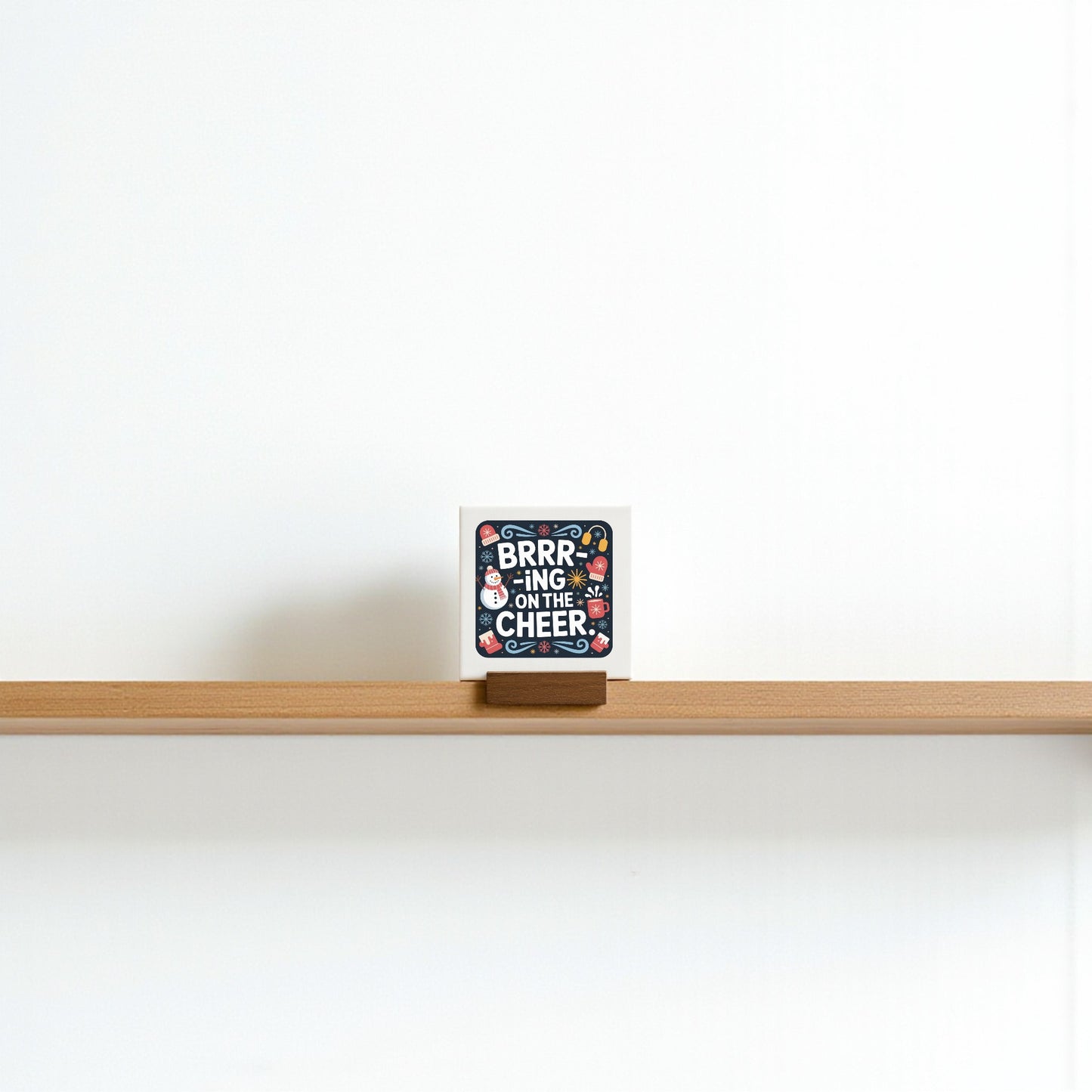 The Mini Brrr-ing on the Cheer Sign by Mirabilia Boutique is a 4x4 holiday shelf decor piece, perfect for tiered trays or as a festive stocking stuffer gift.