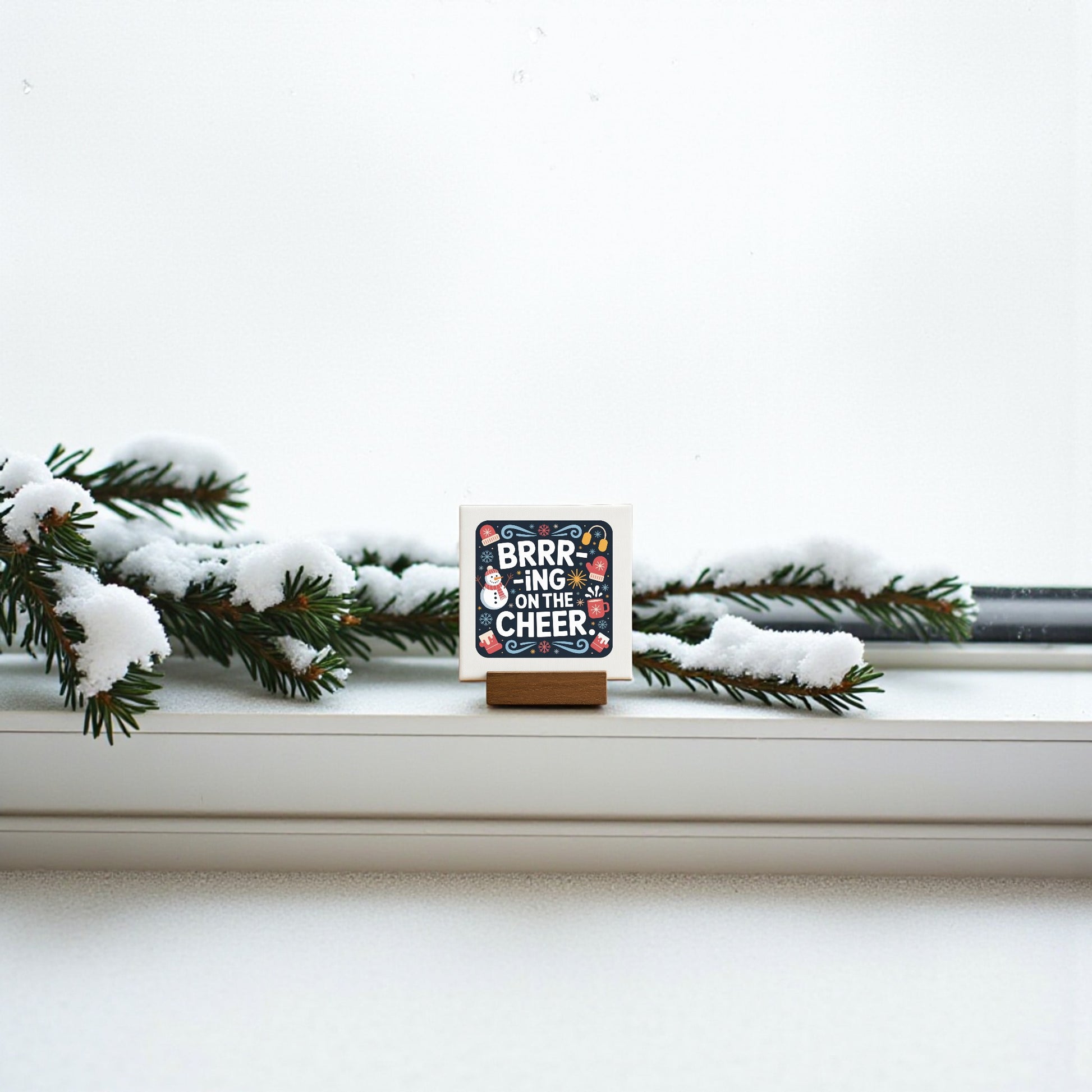 The Mirabilia Boutique Mini Brrr-ing on the Cheer Sign (4x4) adds festive charm to any shelf, tiered tray, or stocking. Its cheerful holiday design makes it a perfect seasonal decor piece or small gift.