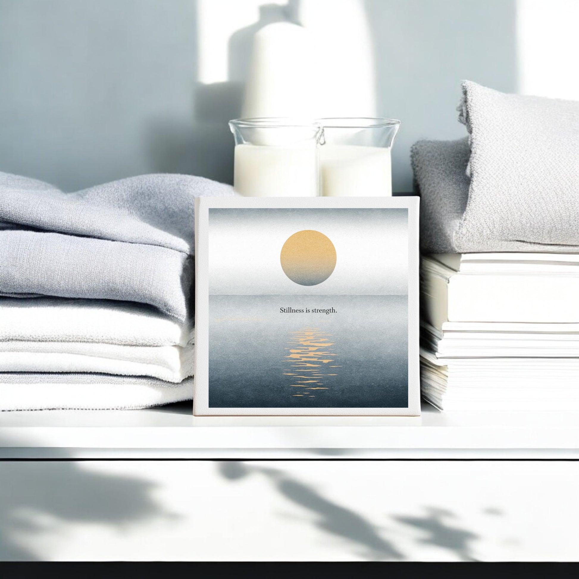 The Mirabilia Boutique "Stillness Is Strength Canvas – Minimalist Calm Wall Art" features a golden sun over tranquil water with its inspiring phrase, ideal meditation decor for peaceful spaces.