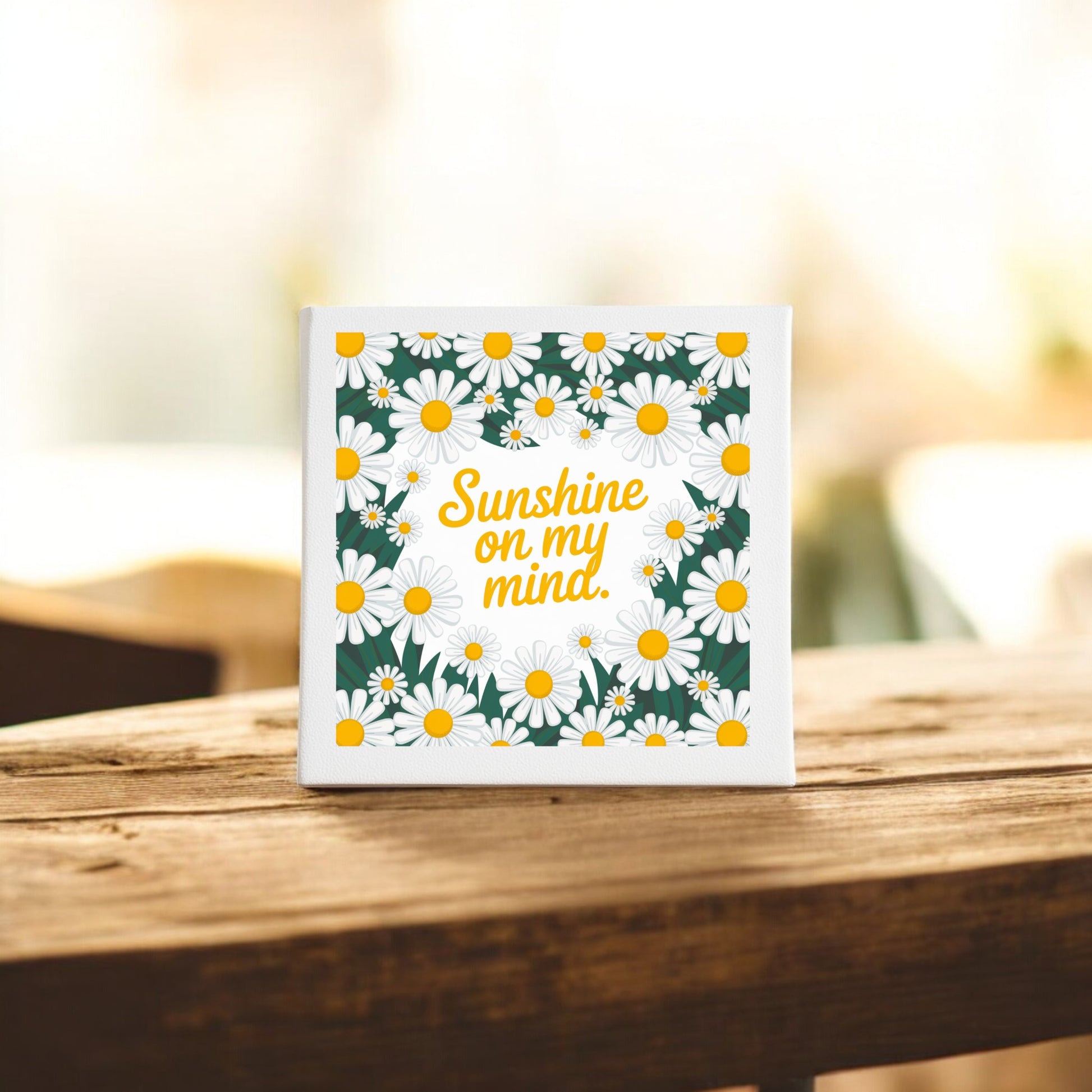 The Mirabilia Boutique Sunshine on My Mind Canvas (8x8) features a square design with white daisies and yellow centers framing “Sunshine on my mind” in yellow script—perfect daisy wall art for brightening any space.
