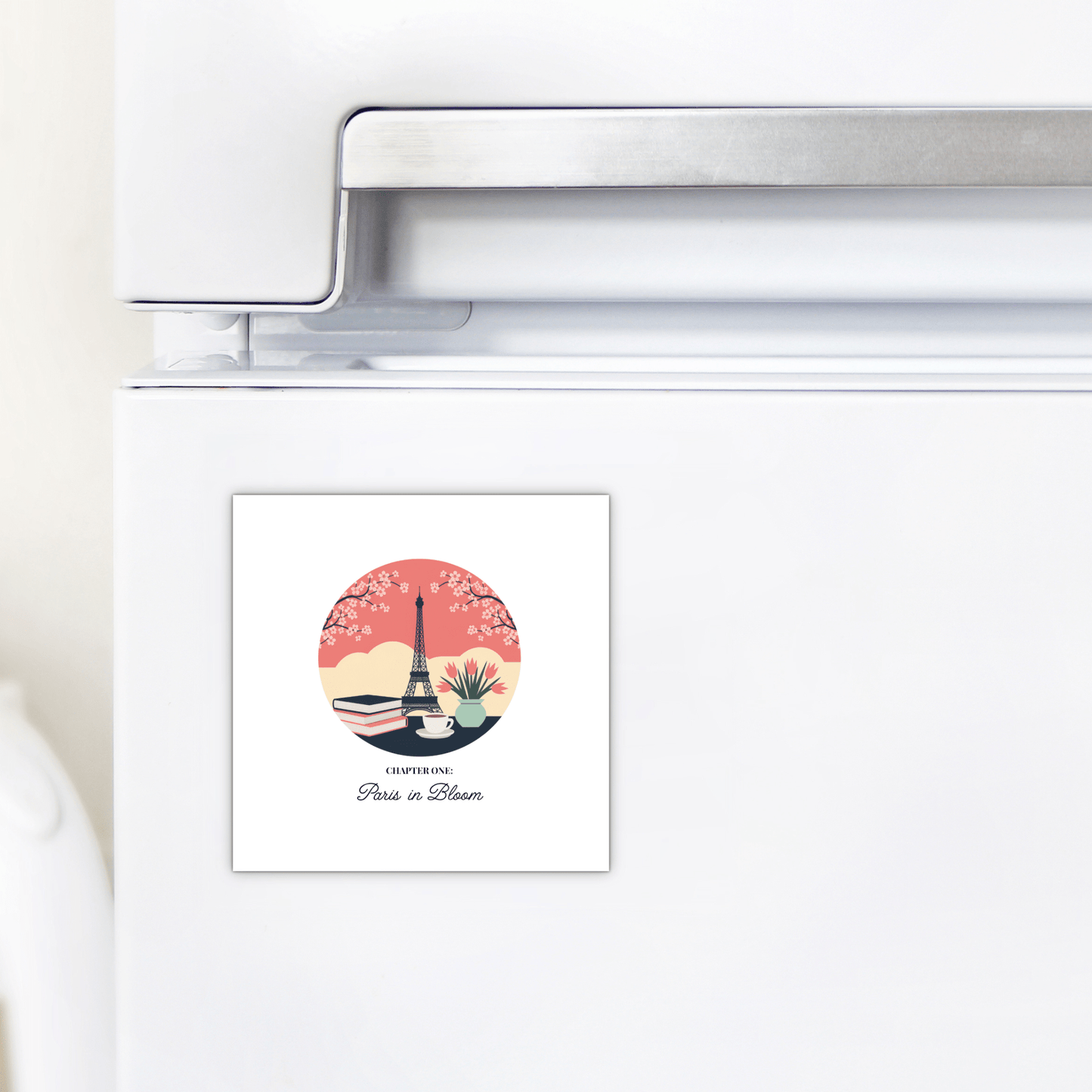 The Paris in Bloom Magnet by Mirabilia Boutique features the Eiffel Tower, cherry blossoms, and "Paris in Bloom" on a pink sunset—perfect cherry blossom décor and a literary gift for book lovers.