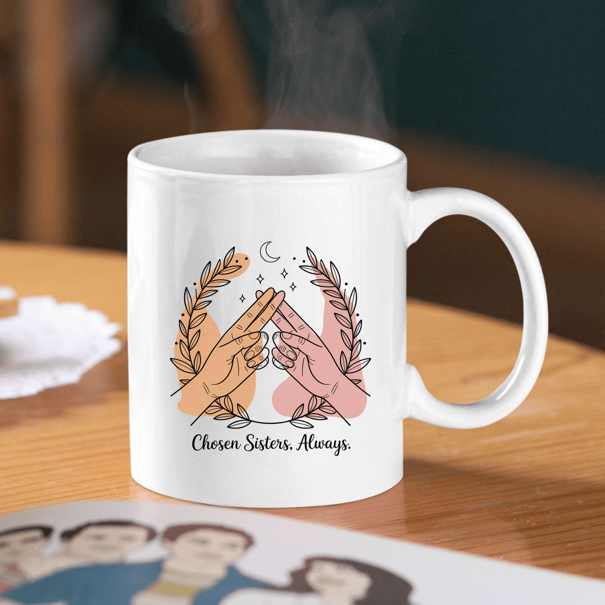 The Best Friend Mug by Mirabilia Boutique features two hands in a pinky promise with leafy branches and a crescent moon, plus “Chosen Sisters, Always” text. A perfect Galentine’s gift or friendship mug for your chosen sisters!.