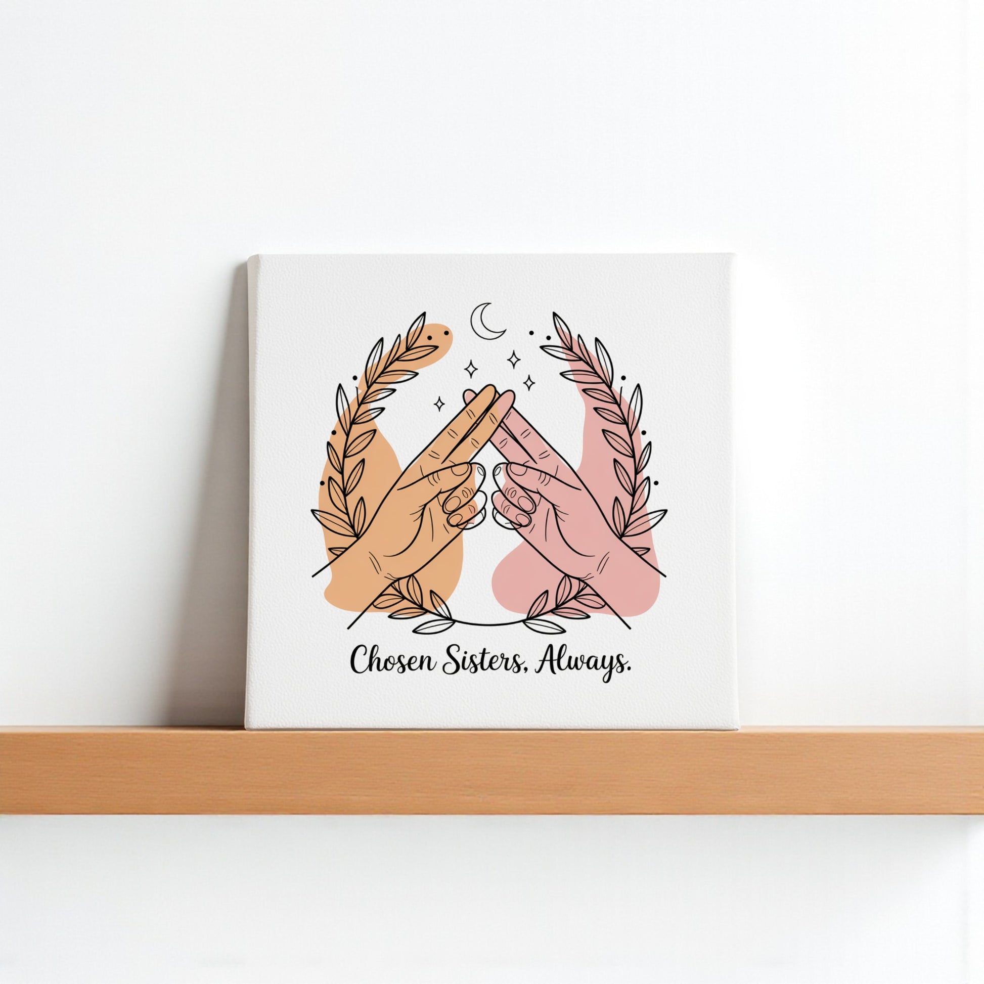 The Chosen Sisters Canvas by Mirabilia Boutique shows two hands of different skin tones touching pinkies under a crescent moon with laurels, captioned "Chosen Sisters. Always."—a heartfelt friendship gift for best friends.