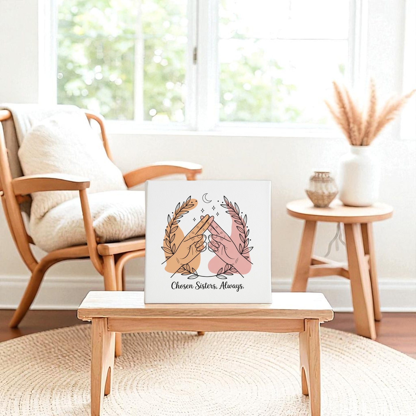 The Chosen Sisters Canvas by Mirabilia Boutique, featuring two hands making a pinky promise and "Chosen Sisters. Always.", rests on a cozy bench—an ideal friendship gift for best friends and sisters.