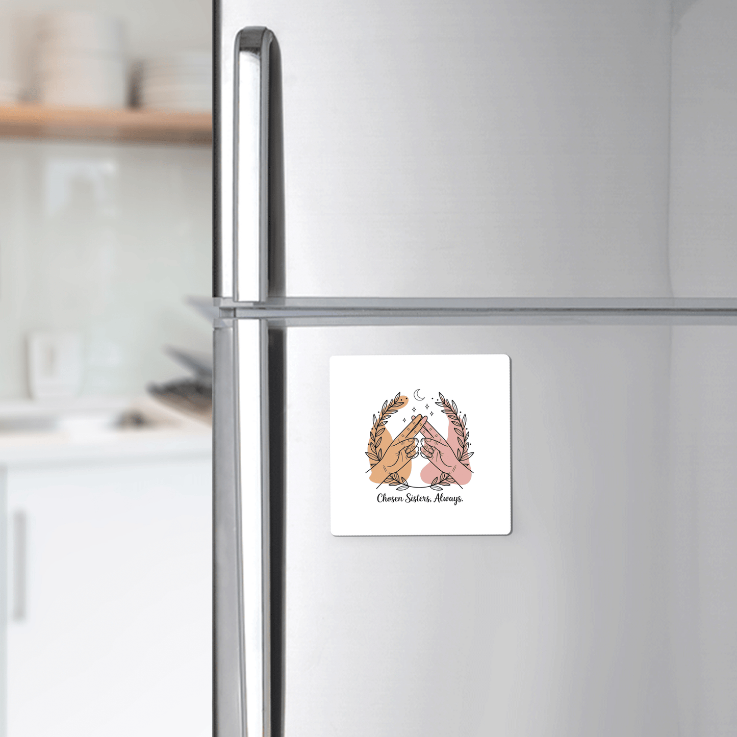 The Chosen Sisters Fridge Magnet by Mirabilia Boutique features two hands making a pinky promise, framed by leaves, on a stainless steel fridge. It reads: "Chism, Sorries, Marops"—a perfect best friend gift for her.