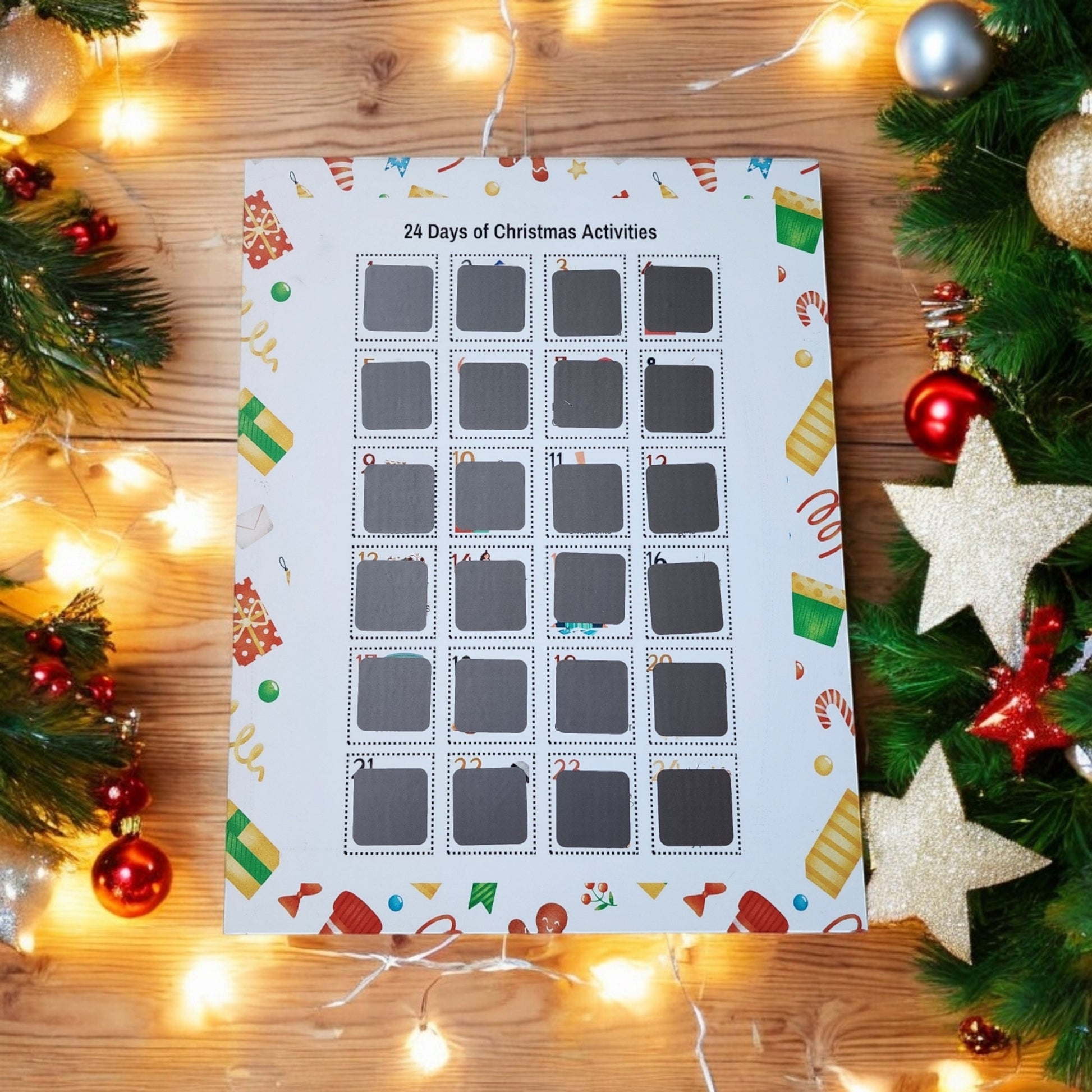 The Mirabilia Boutique's 24 Days of Christmas Activities Scratch Off Calendar is beautifully surrounded by holiday décor, featuring string lights, ornaments, and pine branches, offering 24 days of festive fun.
