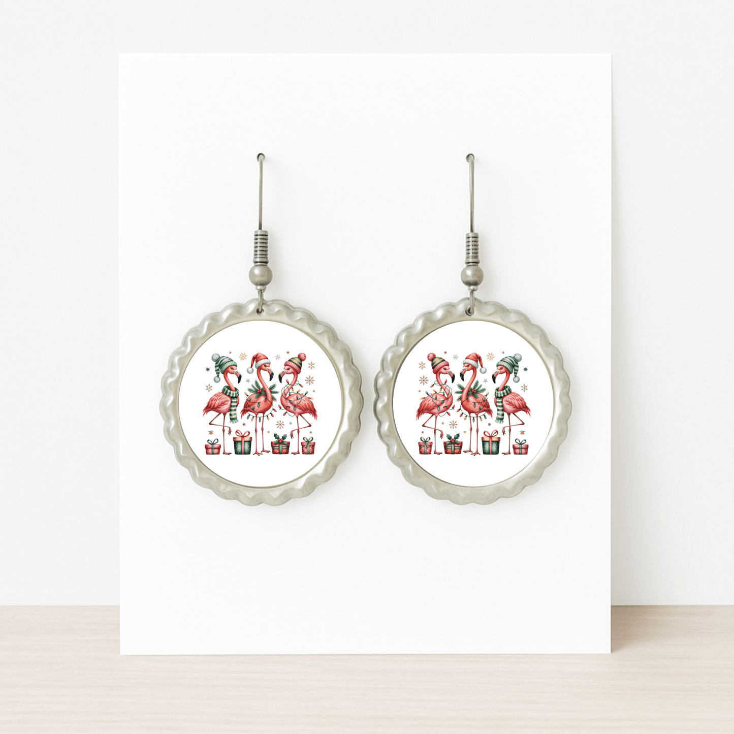 Mirabilia Boutique’s Christmas Flamingo Earrings feature four festive flamingos in holiday hats among presents. These hypoallergenic, tropical holiday jewelry pieces add playful seasonal fun—displayed on a white card.