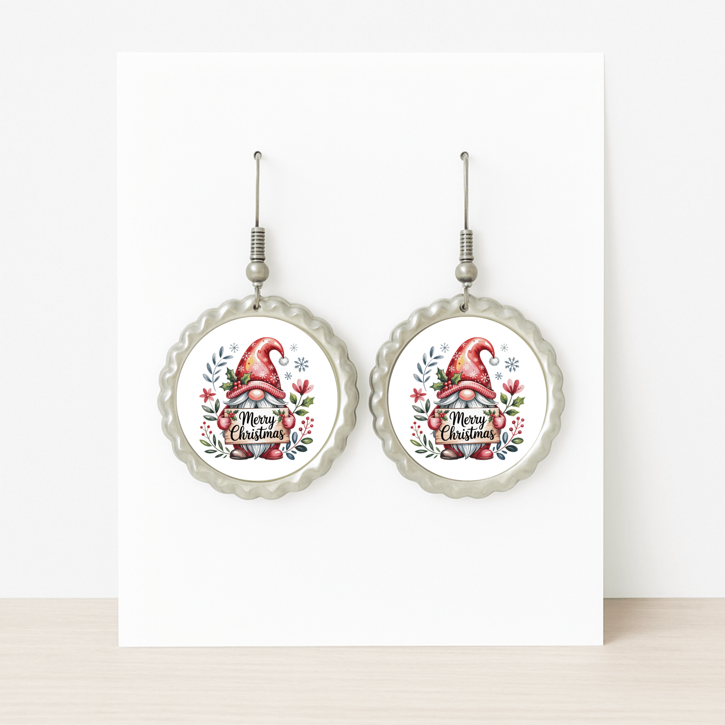 Mirabilia Boutique’s Merry Christmas Christmas Gnome Earrings feature a festive gnome in a red hat with holly and florals, scalloped edges, and “Merry Christmas”—the perfect holiday jewelry gift. Displayed on a white background.