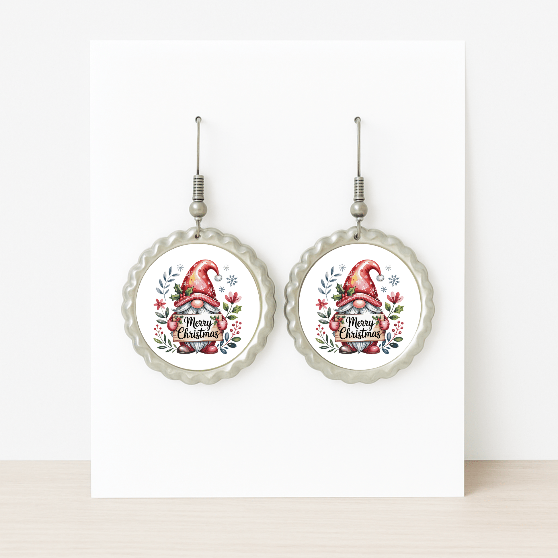 Mirabilia Boutique’s Merry Christmas Christmas Gnome Earrings feature a festive gnome in a red hat with holly and florals, scalloped edges, and “Merry Christmas”—the perfect holiday jewelry gift. Displayed on a white background.