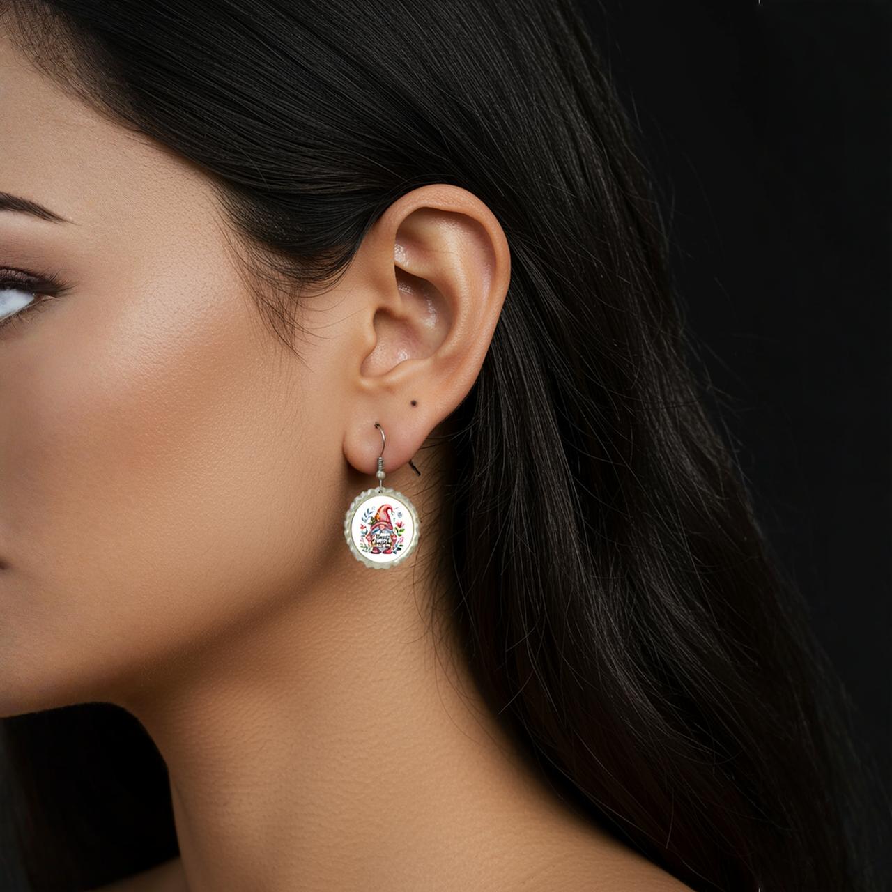 Close-up of a woman in profile against a black background, wearing Mirabilia Boutique's Merry Christmas Christmas Gnome Earrings. Only one eye, ear, and part of her lips are visible; her straight dark hair and smooth skin stand out.