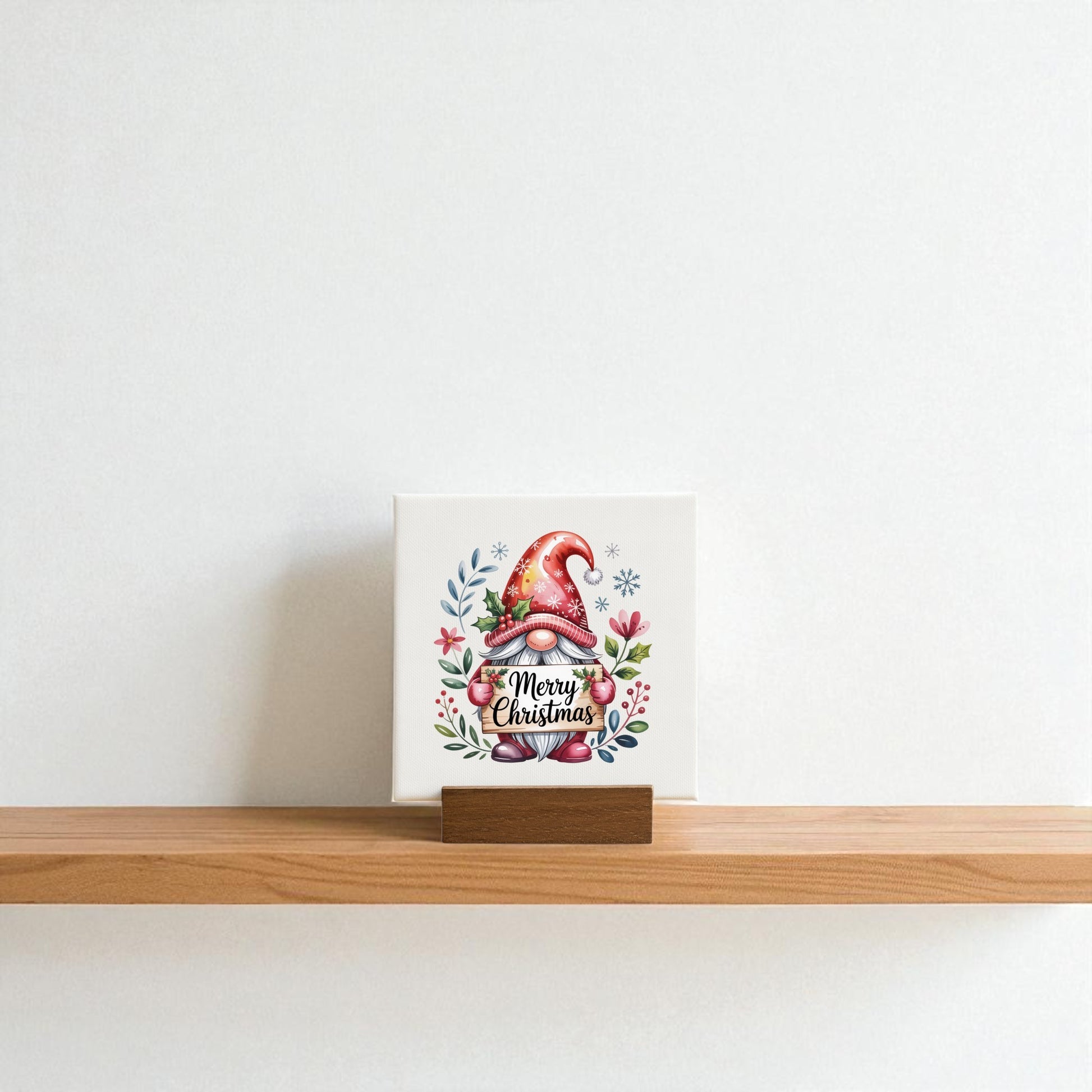 The Mirabilia Boutique Christmas Gnome Mini Sign, a 4x4 canvas with festive leaves, berries, stars, and “Merry Christmas,” is a charming holiday decor piece for your shelf or wall.