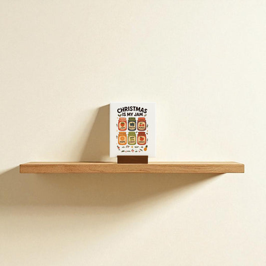 A Christmas Is My Jam Sign by Mirabilia Boutique sits on a wooden floating shelf against a beige wall, adding playful festive charm to your holiday decor.