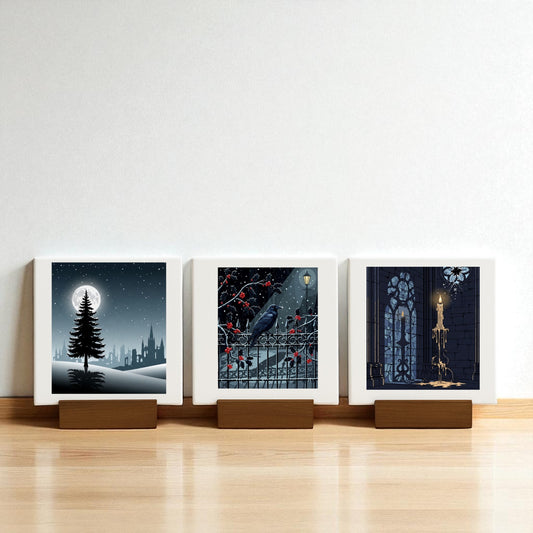 The Christmas Noir Midnight Trio by Mirabilia Boutique features three square prints on wooden stands—a moonlit tree, a raven with red berries, and a candle in a gothic window—ideal gothic holiday decor for your Christmas Noir Mini Canvas collection.