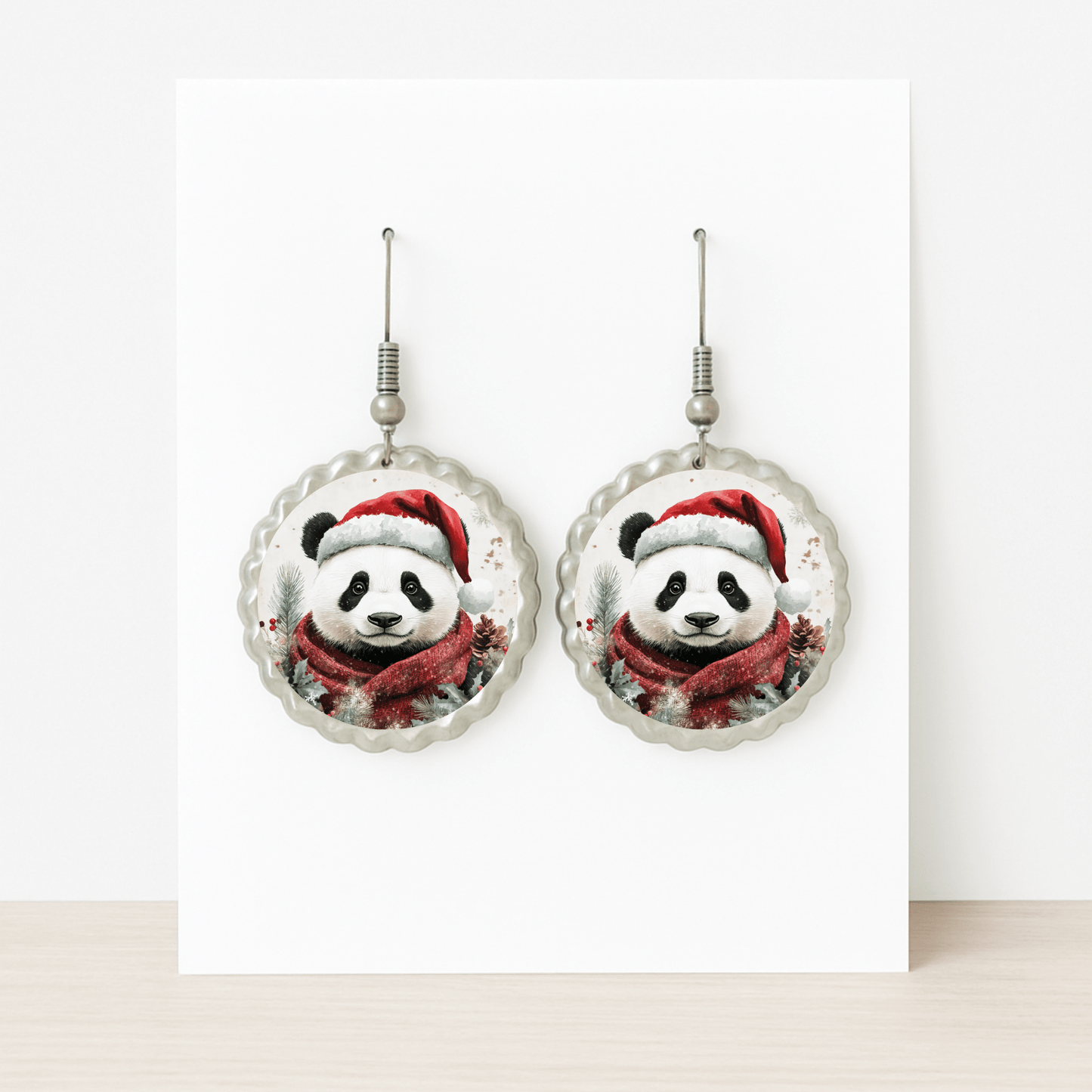 Christmas Panda Earrings by Mirabilia Boutique—cute holiday dangle jewelry with pandas in Santa hats and scarves. Displayed on a white card, they're festive, hypoallergenic, and perfect for sensitive ears.
