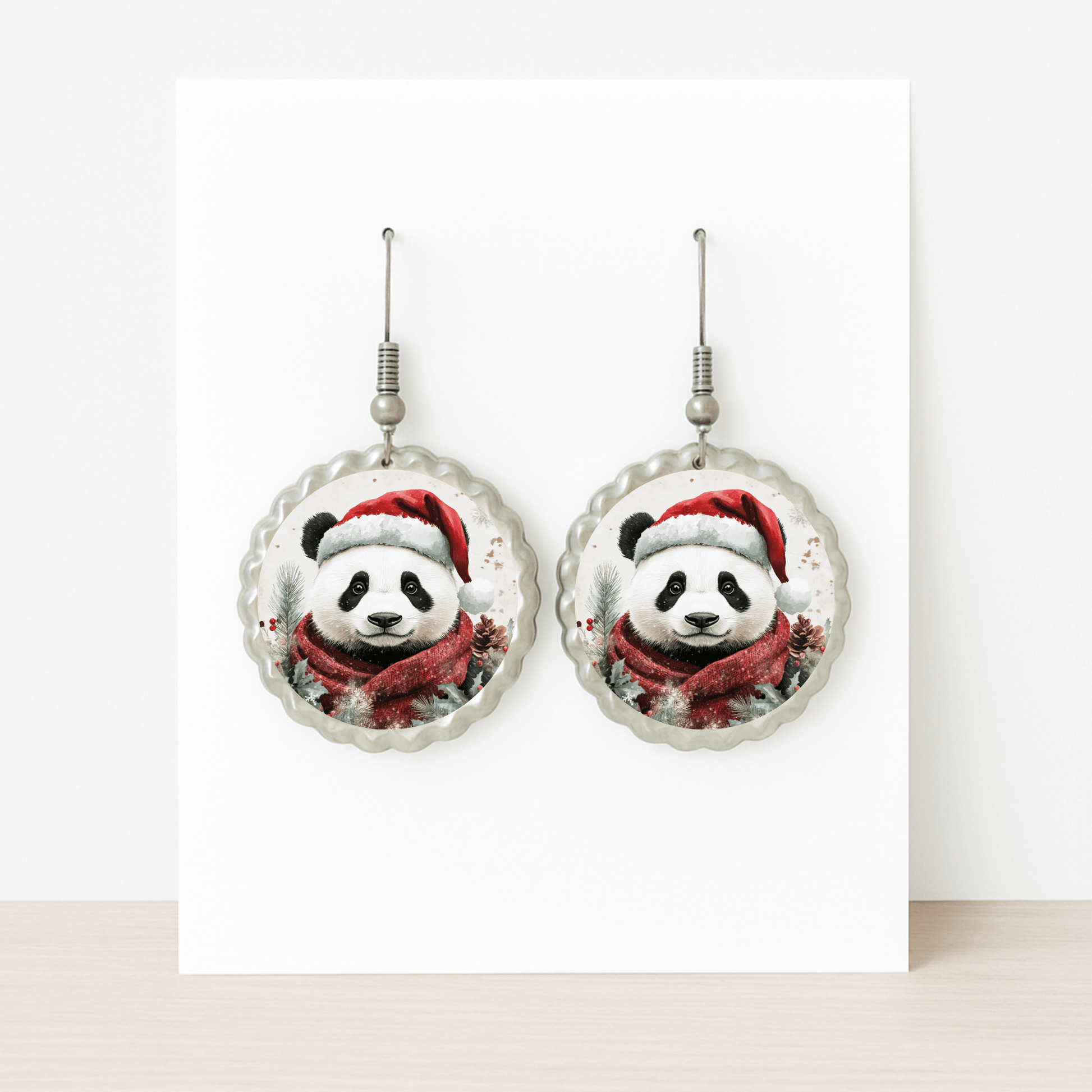 Christmas Panda Earrings by Mirabilia Boutique—cute holiday dangle jewelry with pandas in Santa hats and scarves. Displayed on a white card, they're festive, hypoallergenic, and perfect for sensitive ears.