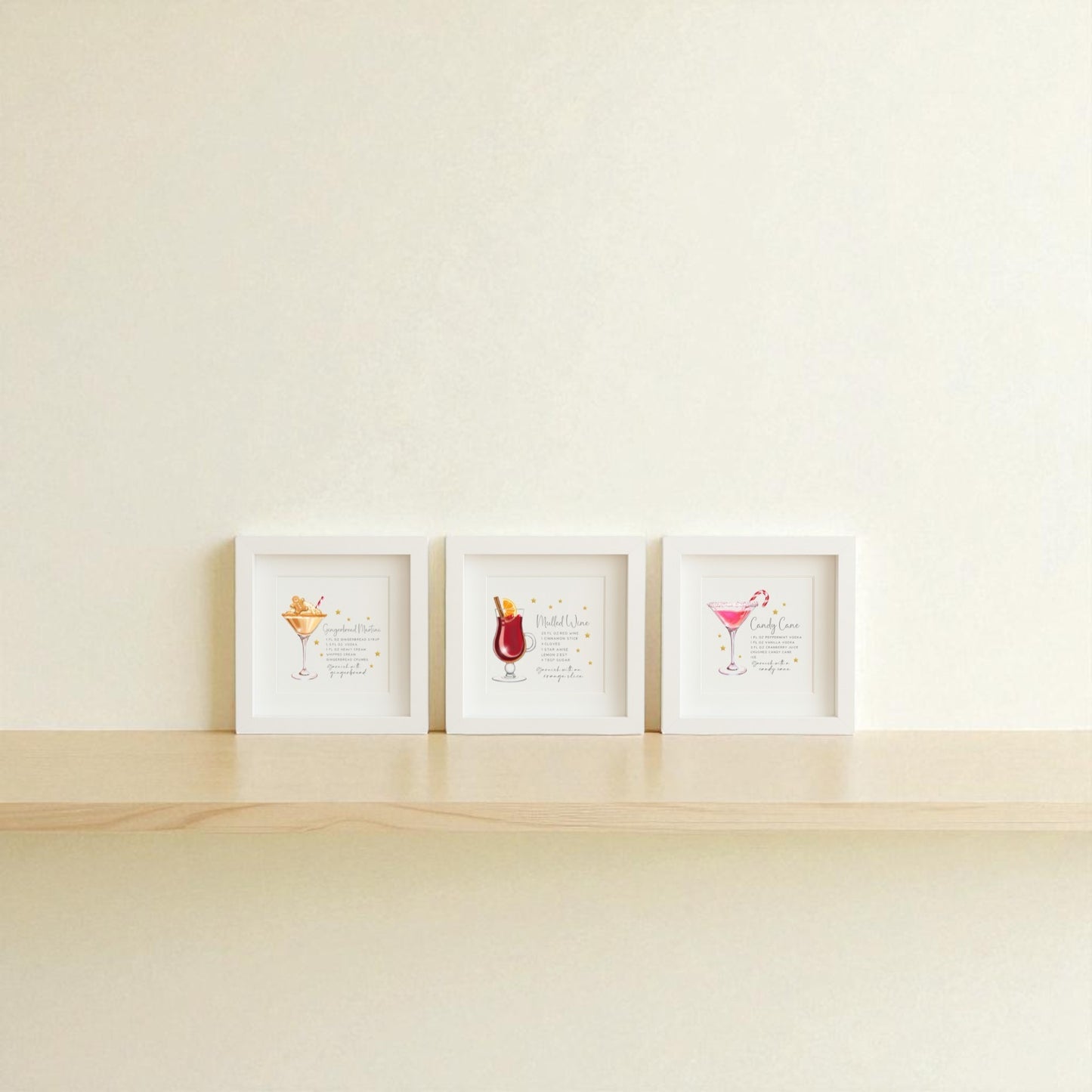 The Classic Christmas Cocktails 5x5 Shadowbox Trio by Mirabilia Boutique features festive holiday bar art, displayed side by side on a light wooden shelf against an off-white wall.