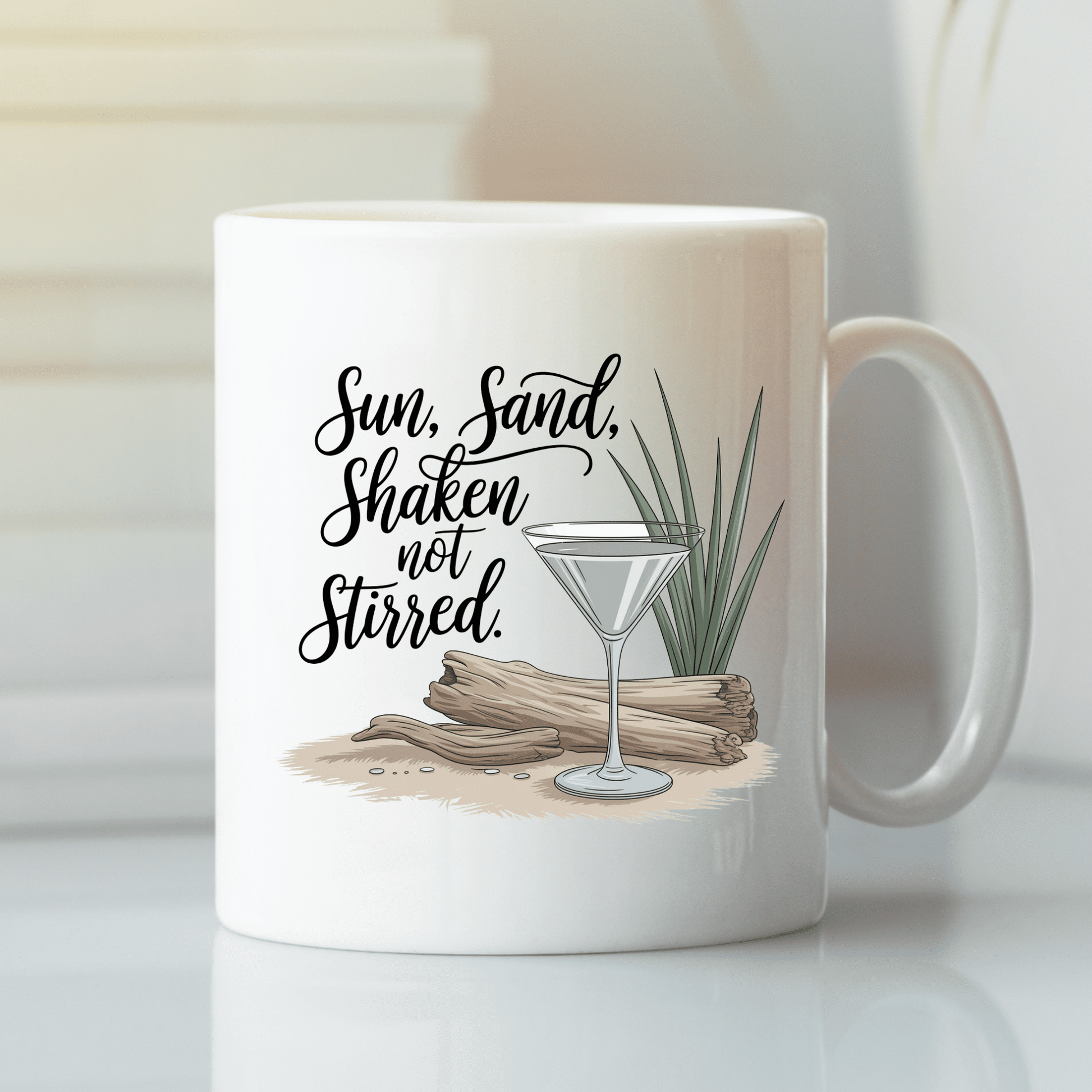 The Sun, Sand, Shaken Not Stirred Mug – Coastal Coffee Vibe by Mirabilia Boutique features a martini glass, driftwood, sand, and beach grass with “Sun, Sand, Shaken not Stirred”—ideal for stylish beach house decor.