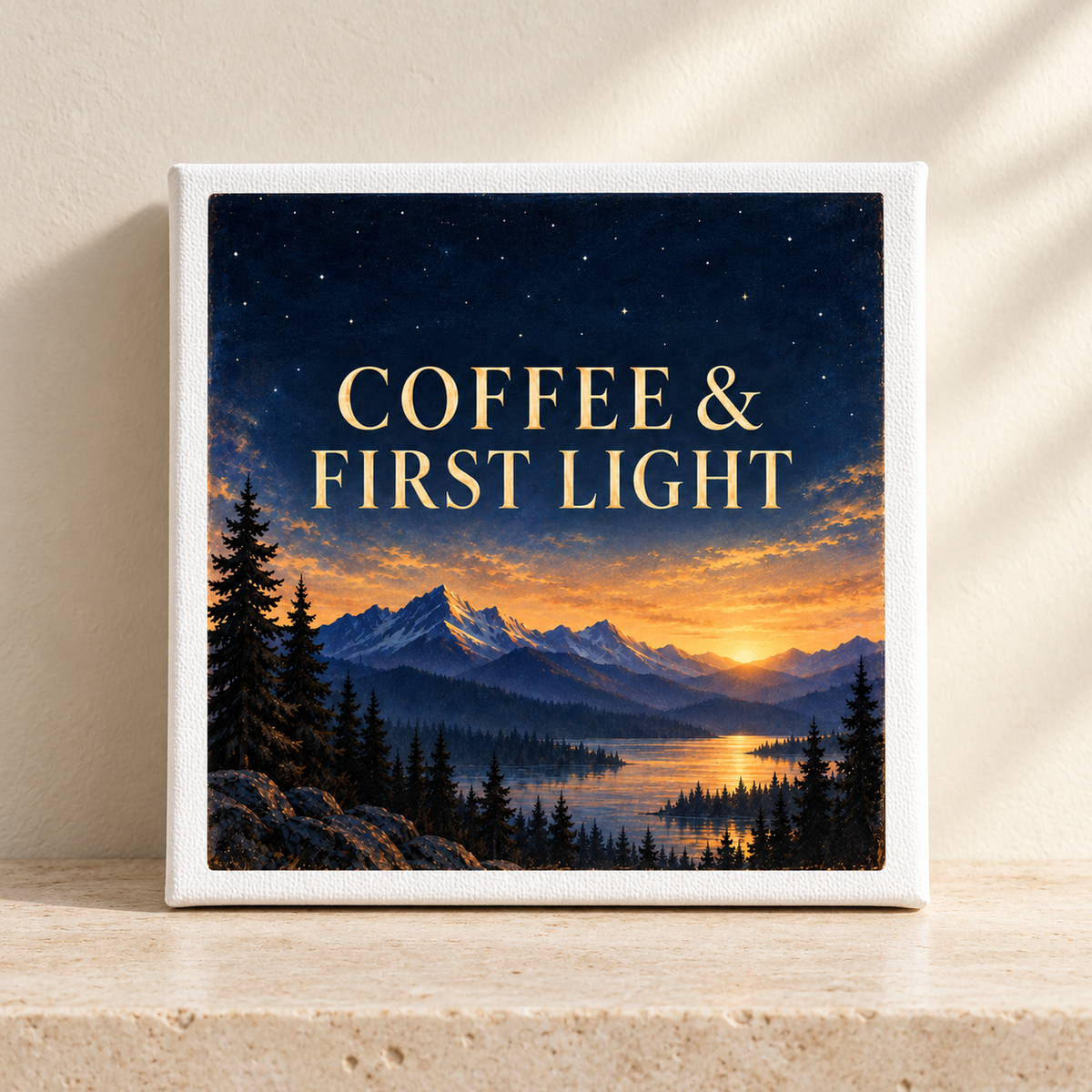 The Coffee & First Light 8x8 Canvas Coffee Bar Sign by Mirabilia Boutique displays the phrase “COFFEE & FIRST LIGHT” above a scenic sunrise with mountains, trees, and a river, creating captivating mountain sunrise art. Perfect as coffee bar decor from Star & Solstice, this canvas rests on a stone surface against a beige wall.