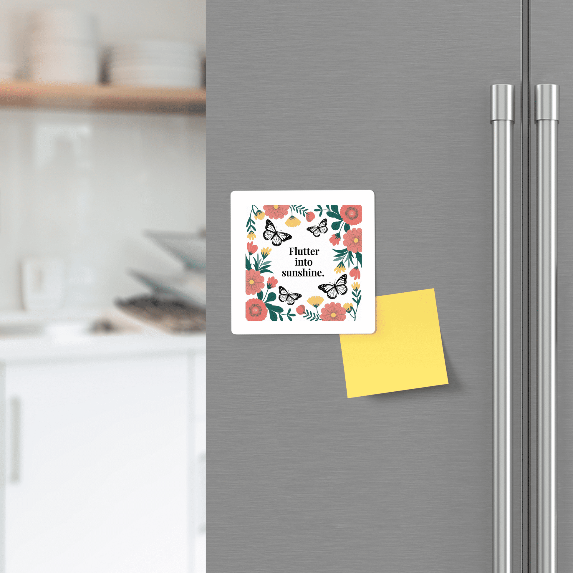 The Mirabilia Boutique Flutter into Sunshine Magnet – Butterfly & Floral Joy brings a cheerful message and vibrant design to your silver fridge, paired with a yellow sticky note, brightening any modern kitchen with white cabinets and dishes.