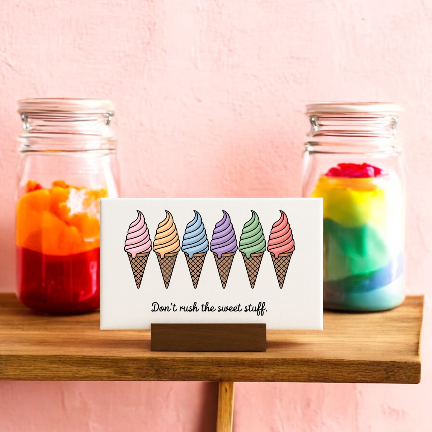 The “Don’t Rush the Sweet Stuff – Canvas Ice Cream Sign” by Mirabilia Boutique features six colorful ice cream illustrations, bringing a playful pastel vibe to your space and brightening up any shelf or wall.