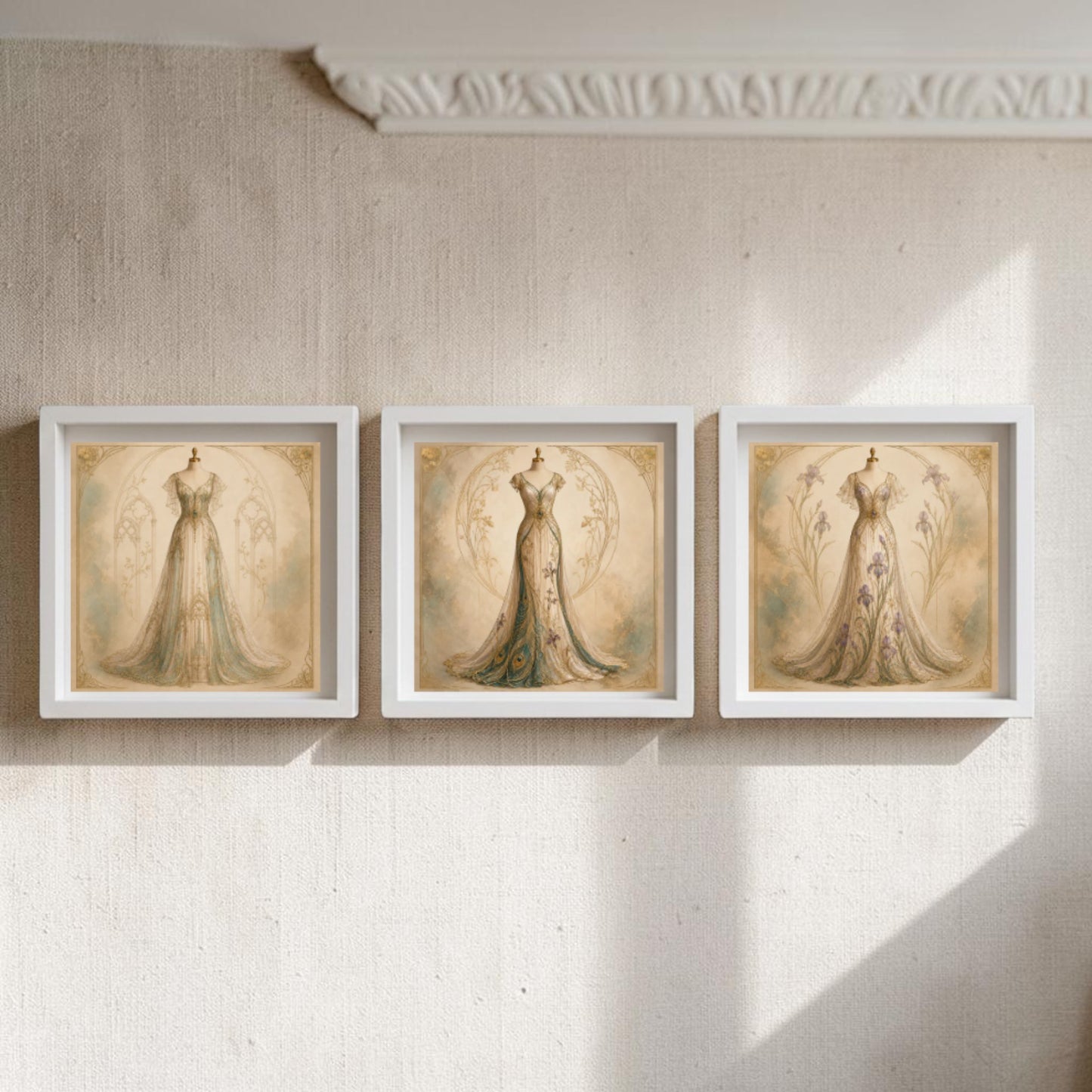 Three framed canvas pieces from Mirabilia Boutique’s Conservatory Collection | Curated Couture Artwork, each depicting an elegant vintage dress on a mannequin, are displayed in a row on a textured wall, softly illuminated by natural light streaming in from the right.