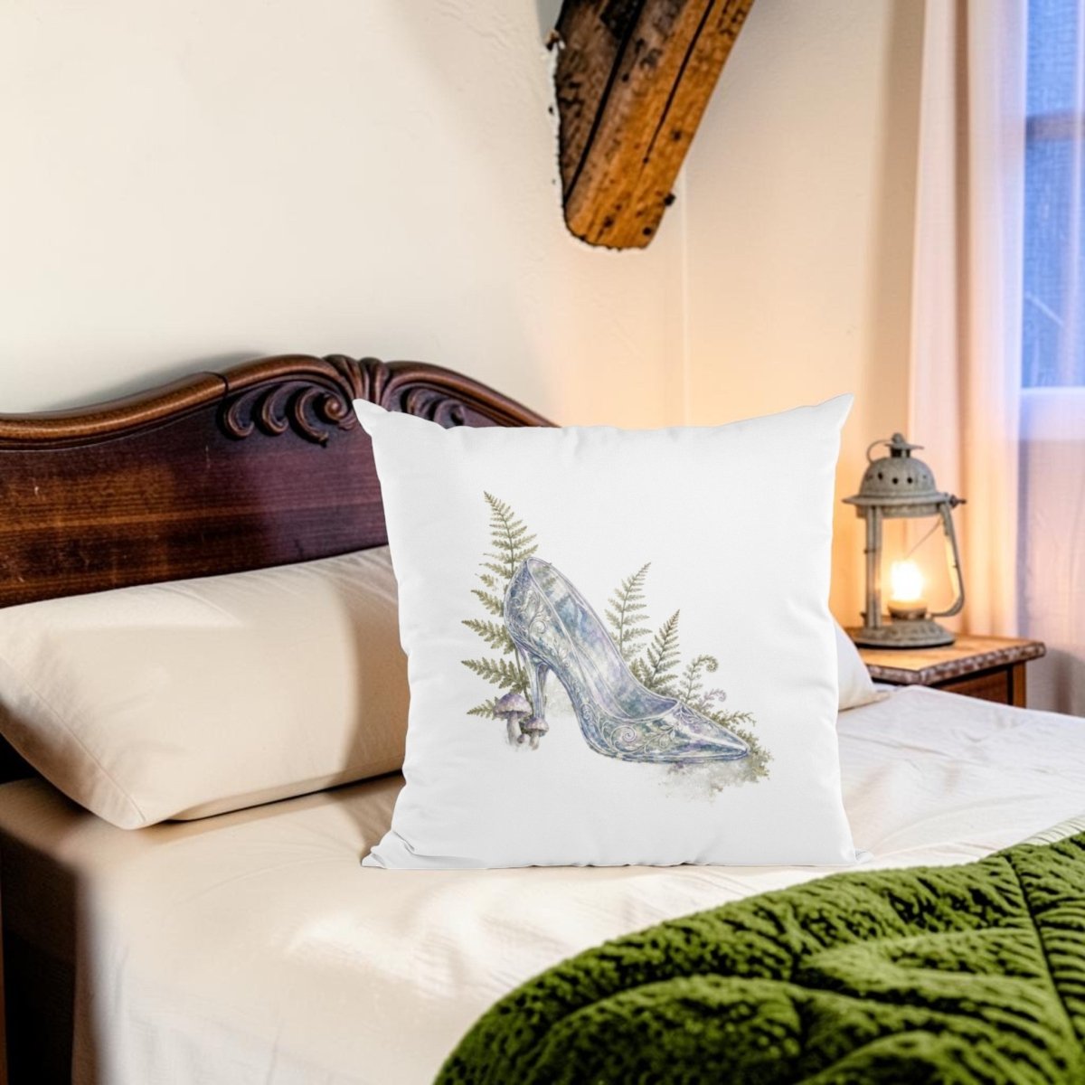 The Enchanted Glass Slipper Throw Pillow by Mirabilia Boutique rests on a neatly made bed with a wooden headboard. A lantern glows on the nightstand by the window, while a green blanket at the foot of the bed enhances the enchanting, fairytale-inspired décor of this cozy scene.