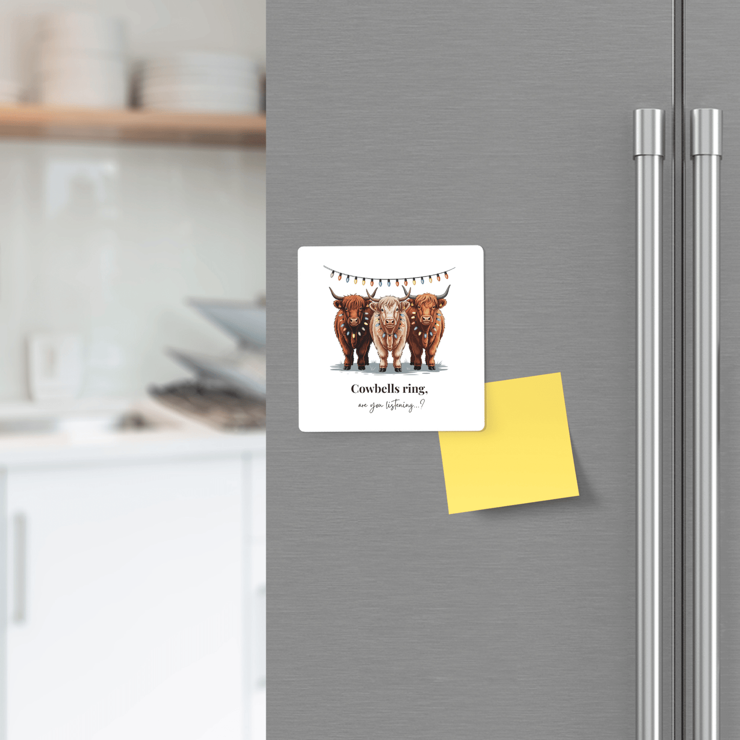On a fridge door, a Mirabilia Boutique "Highland Cow Christmas Magnet | Cute Cowbells Ring Gift" shows three cows in festive wreaths—a perfect cow lover gift or farmhouse holiday decor. A blank yellow sticky note and cozy kitchen set the scene.