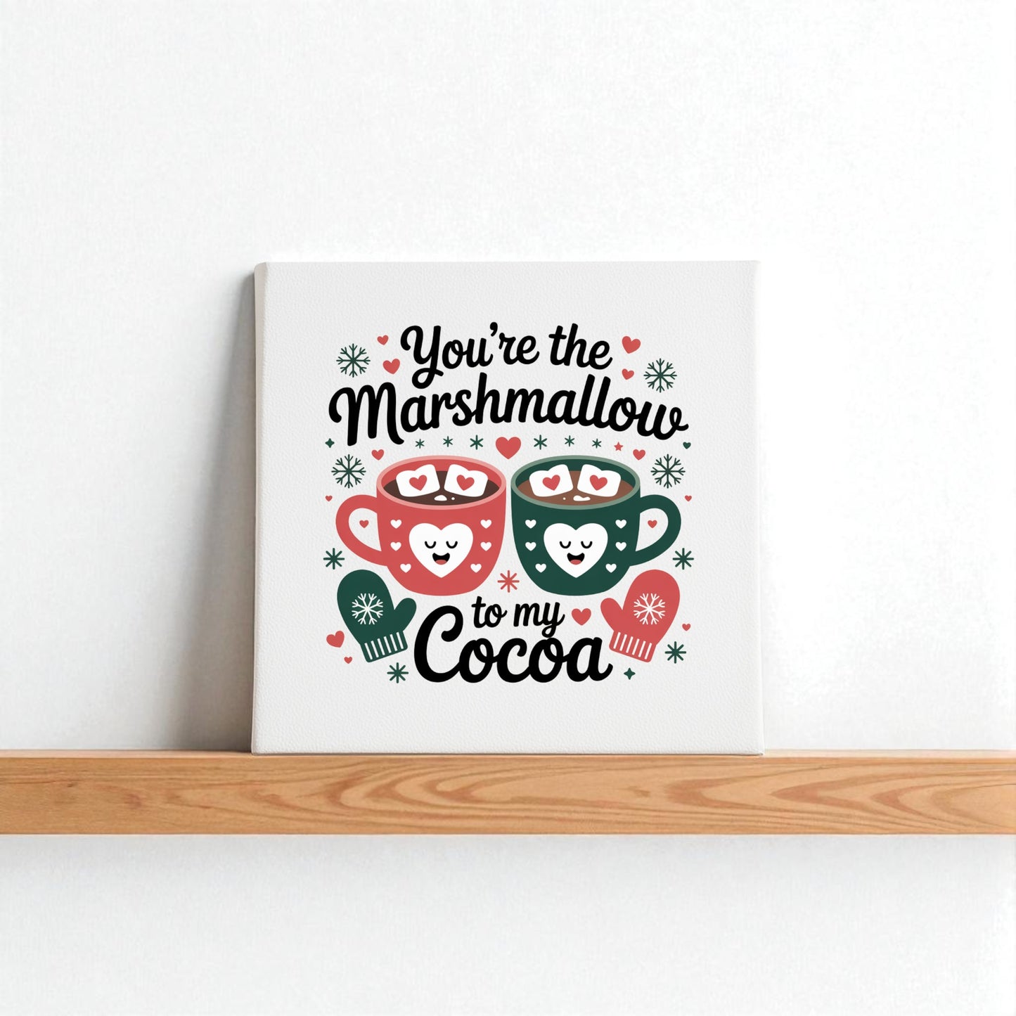 The Marshmallow to My Cocoa Sign by Mirabilia Boutique is an 8x8 winter canvas art, featuring two smiling mugs with hearts and snowflakes and the phrase “You’re the marshmallow to my cocoa”—perfect cozy kitchen decor.