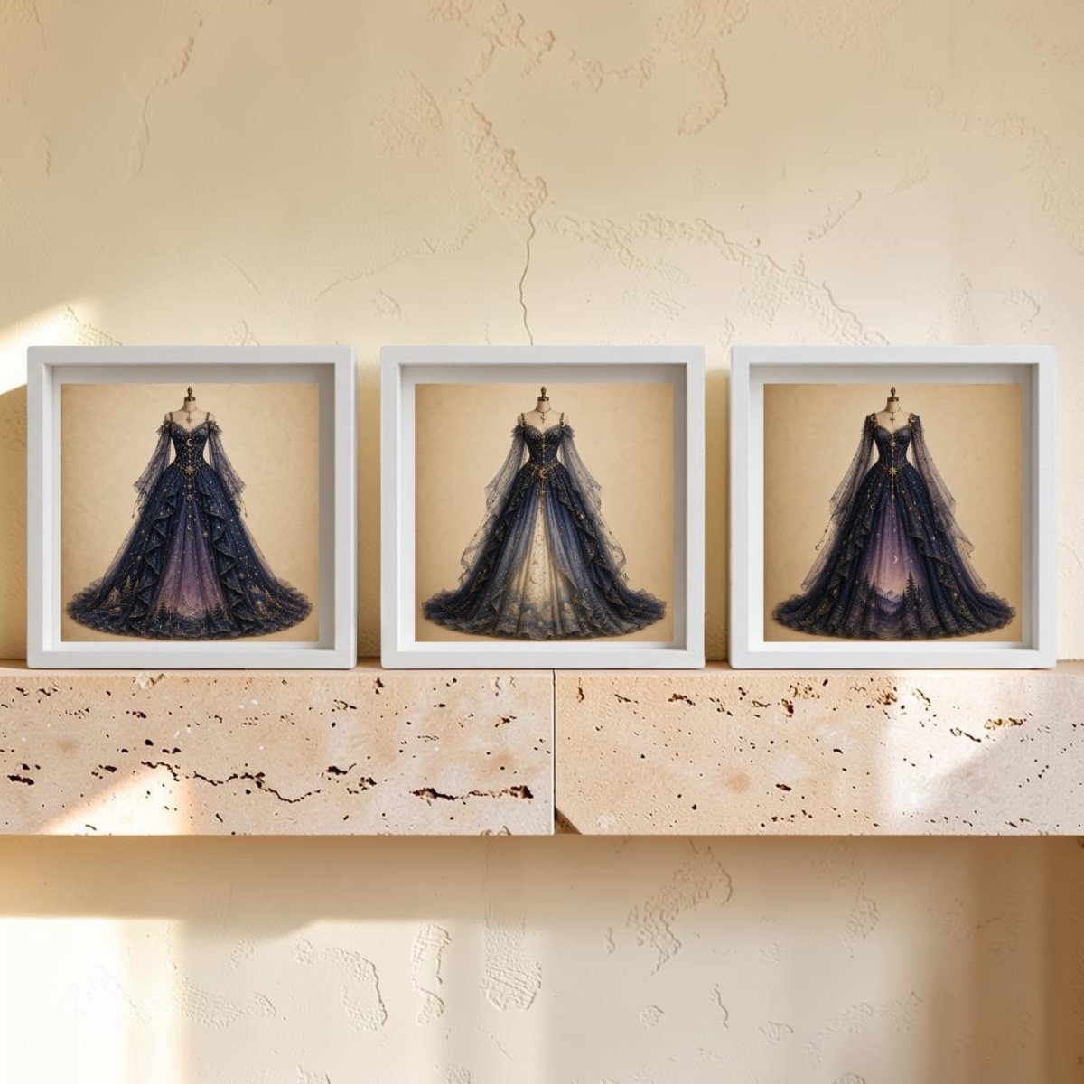 Three framed prints from Mirabilia Boutique’s Celestial Reverie | Curated Couture Artwork collection, featuring elegant, ornate gowns with long trains, are displayed side by side on a light stone shelf against a textured beige wall, creating a stunning piece of decorative wall art.