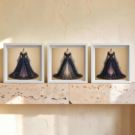 Three framed prints from Mirabilia Boutique’s Celestial Reverie | Curated Couture Artwork collection, featuring elegant, ornate gowns with long trains, are displayed side by side on a light stone shelf against a textured beige wall, creating a stunning piece of decorative wall art.