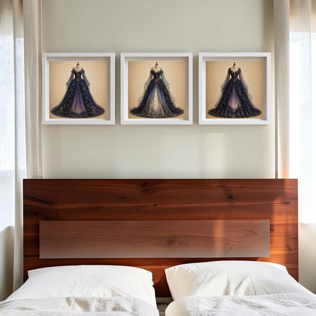 A wooden bed with white pillows sits below three pieces of Mirabilia Boutique’s Celestial Reverie | Curated Couture Artwork, featuring elegant dark-hued dresses on canvas, displayed on a light wall between two bright windows.