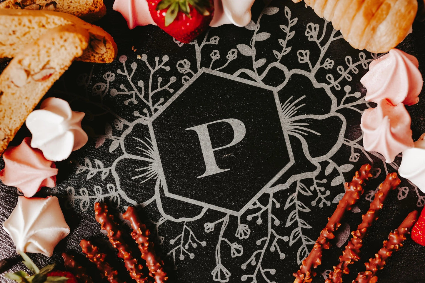 The Mirabilia Boutique Personalized Engraved Slate Serving Tray with Handles features a floral monogram and large "P" in the center, ideal for serving cookies, pastries, fruit, or treats—making it a perfect custom gift.