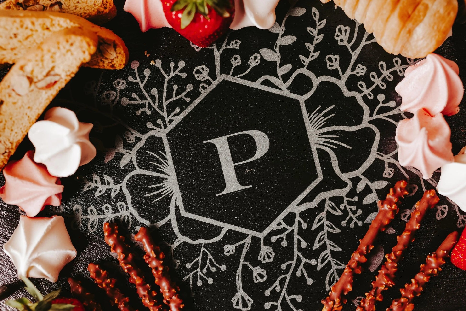 The Mirabilia Boutique Personalized Engraved Slate Serving Tray with Handles features a floral monogram and large "P" in the center, ideal for serving cookies, pastries, fruit, or treats—making it a perfect custom gift.