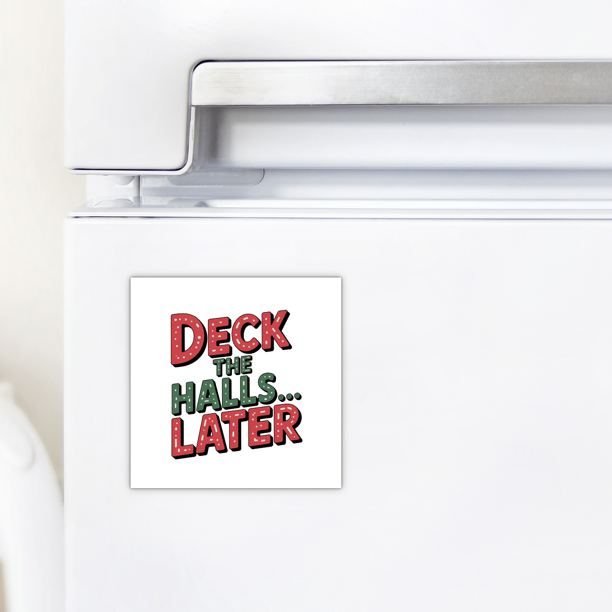 The Deck The Halls... Later Magnet by Mirabilia Boutique is a square, festive fridge magnet with red and green lettering—a funny Christmas gift idea or quirky stocking stuffer.