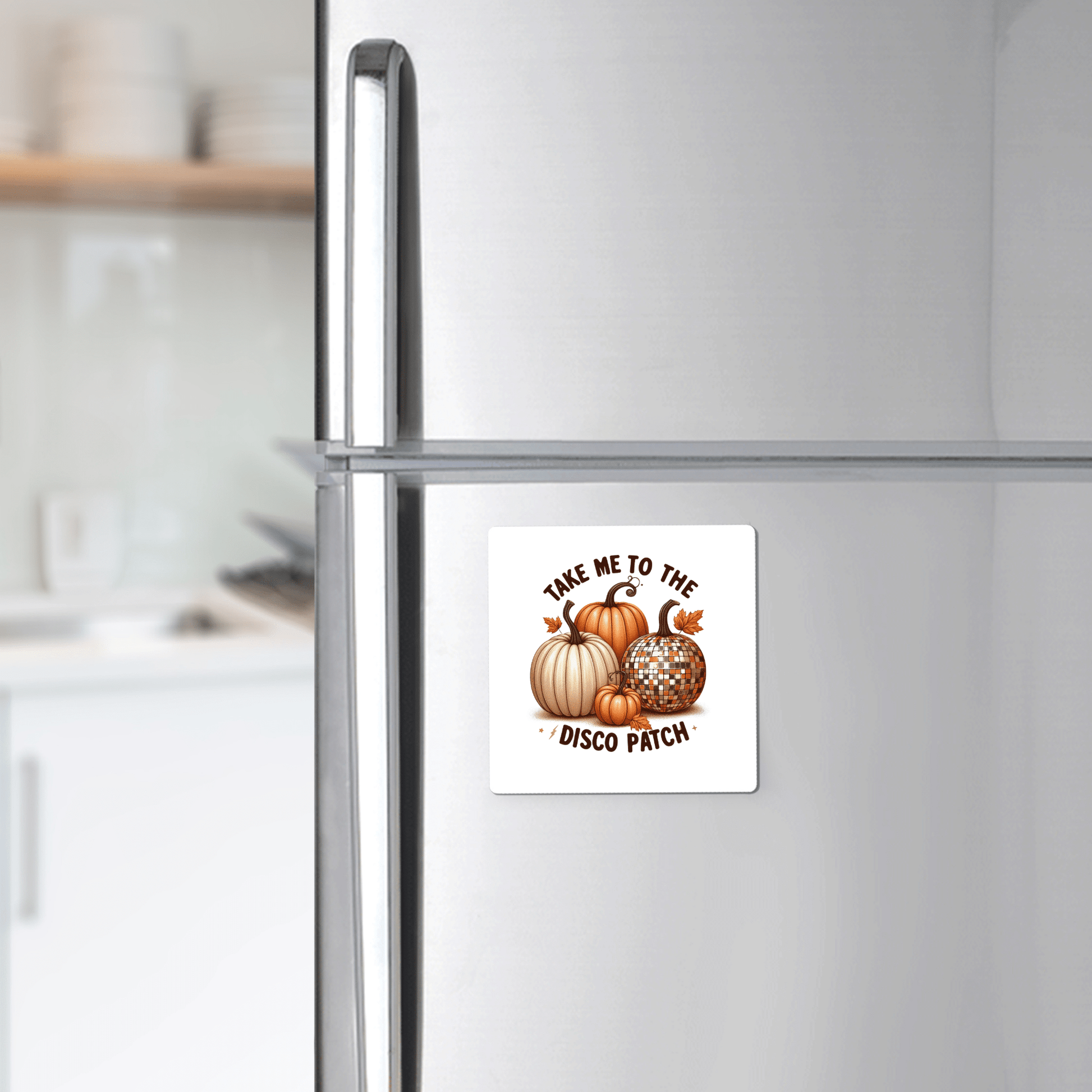 The Disco Patch Pumpkin Magnet by Mirabilia Boutique adds retro flair to your fridge, featuring pumpkins and disco balls with "Take me to the disco patch"—a perfect touch of fun fall decor for your modern kitchen.
