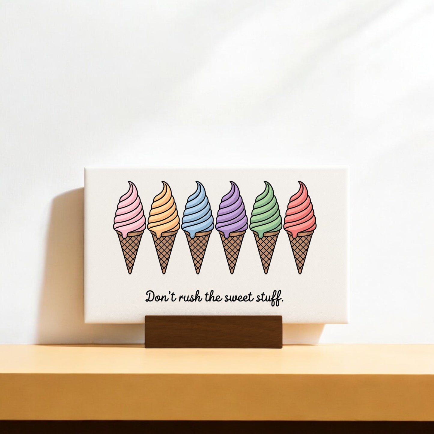 The Mirabilia Boutique "Don’t Rush the Sweet Stuff – Canvas Ice Cream Sign" features six colorful cones and the quote beneath—an adorable pastel decor piece for ice cream lovers.