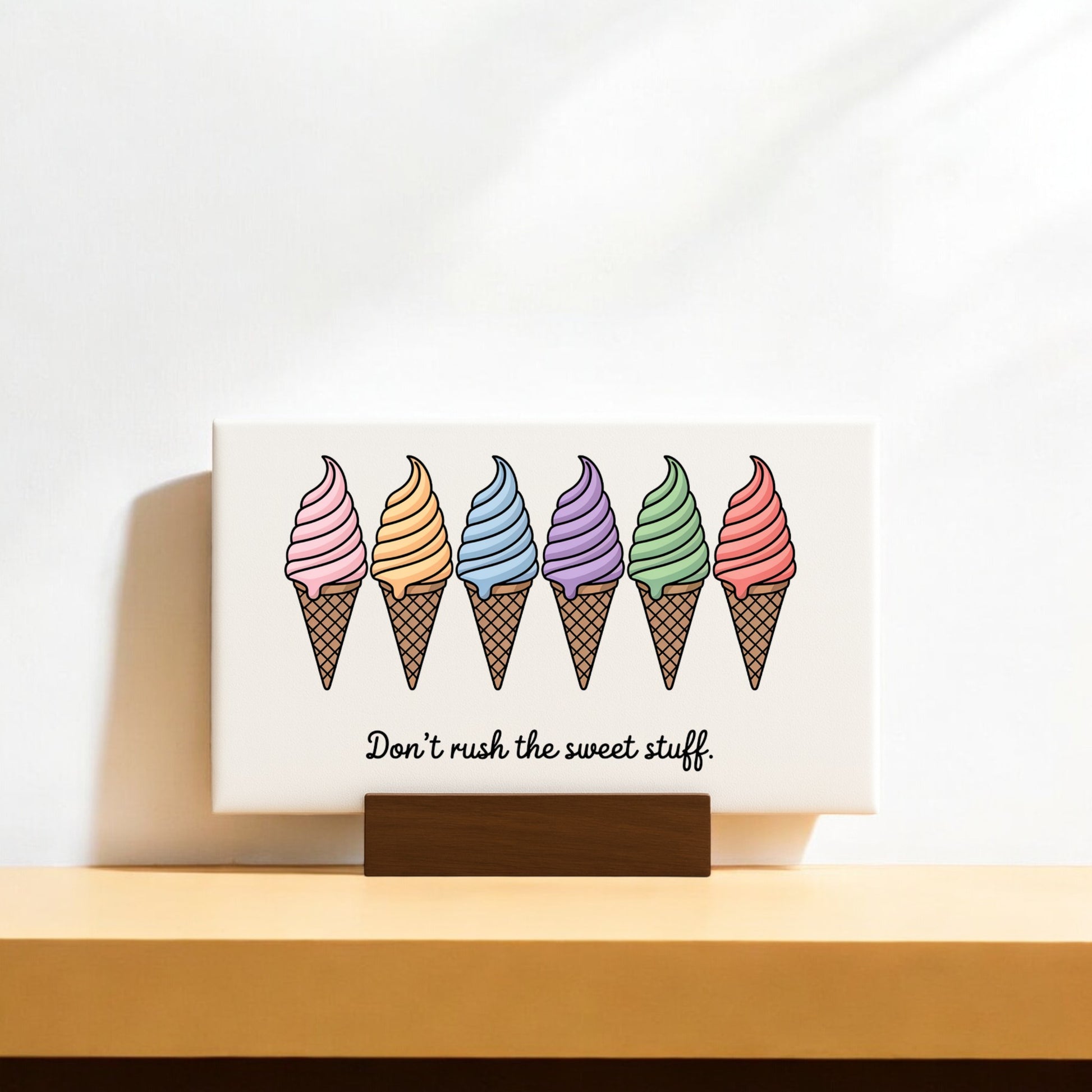 The Mirabilia Boutique "Don’t Rush the Sweet Stuff – Canvas Ice Cream Sign" features six colorful cones and the quote beneath—an adorable pastel decor piece for ice cream lovers.