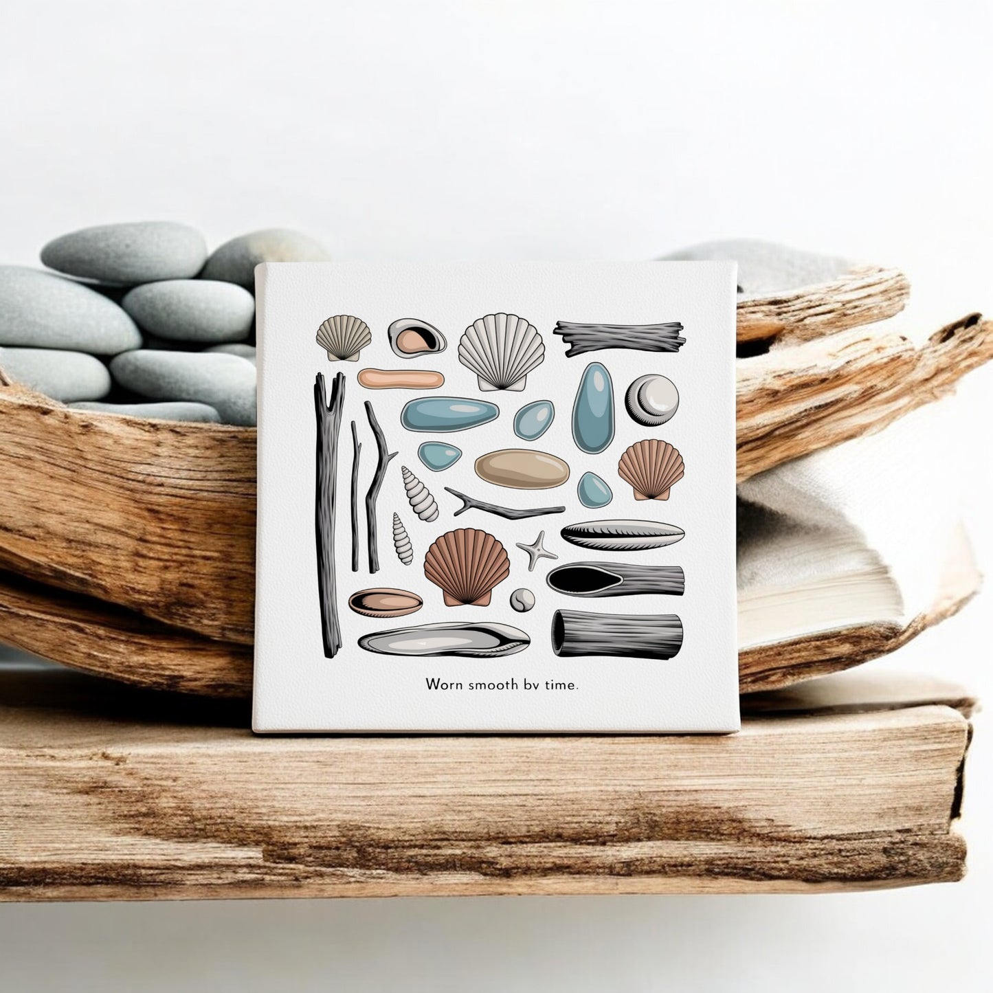 The "Worn Smooth by Time Canvas – Coastal Shell & Driftwood Art" by Mirabilia Boutique is a small, beach-inspired square canvas featuring seashells, pebbles, driftwood, and sea glass—perfect for serene home decor.
