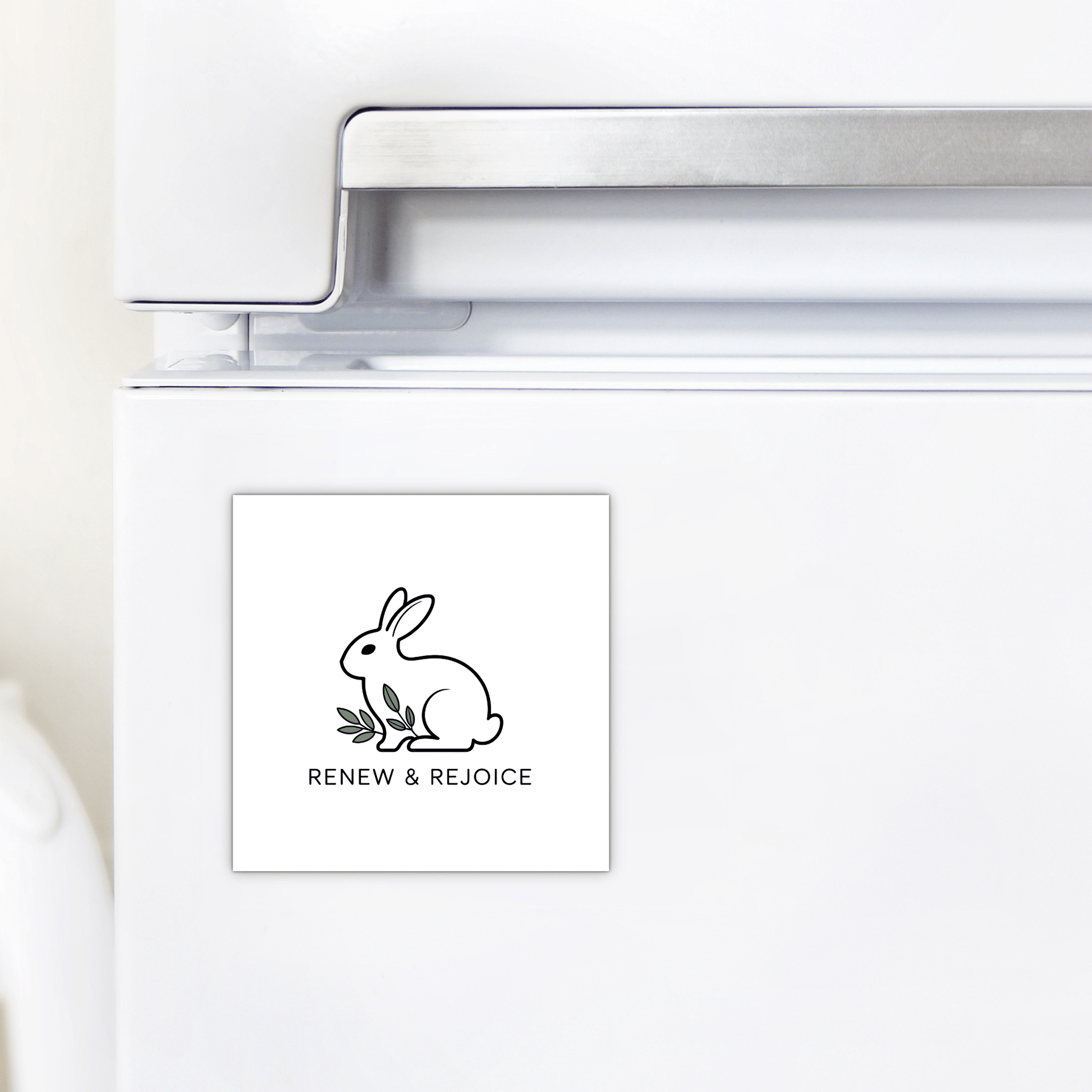 The Renew & Rejoice Magnet – Minimalist Bunny Design by Mirabilia Boutique features a simple bunny line drawing and “RENEW & REJOICE” text—a delightful mindfulness reminder and perfect Easter basket filler for your fridge.