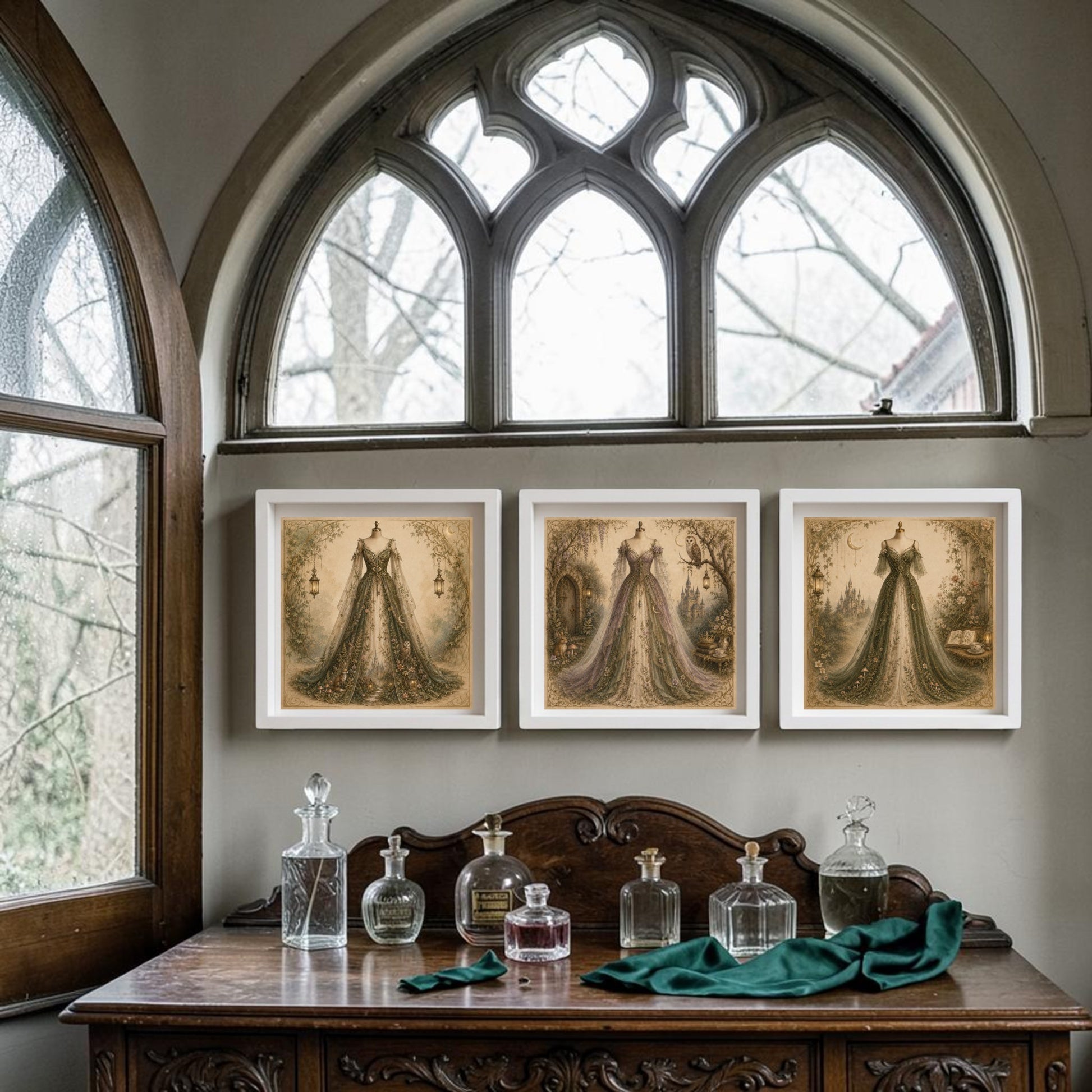 A Victorian-style room features an ornate wooden dresser adorned with glass perfume bottles and draped in green fabric, beneath a gothic arched window framing views of trees outside. Along the walls, the "Enchanted Hollow | Curated Couture Artwork" collection by Mirabilia Boutique showcases elegant women on framed canvases, enchanting the space with woodland-inspired art.