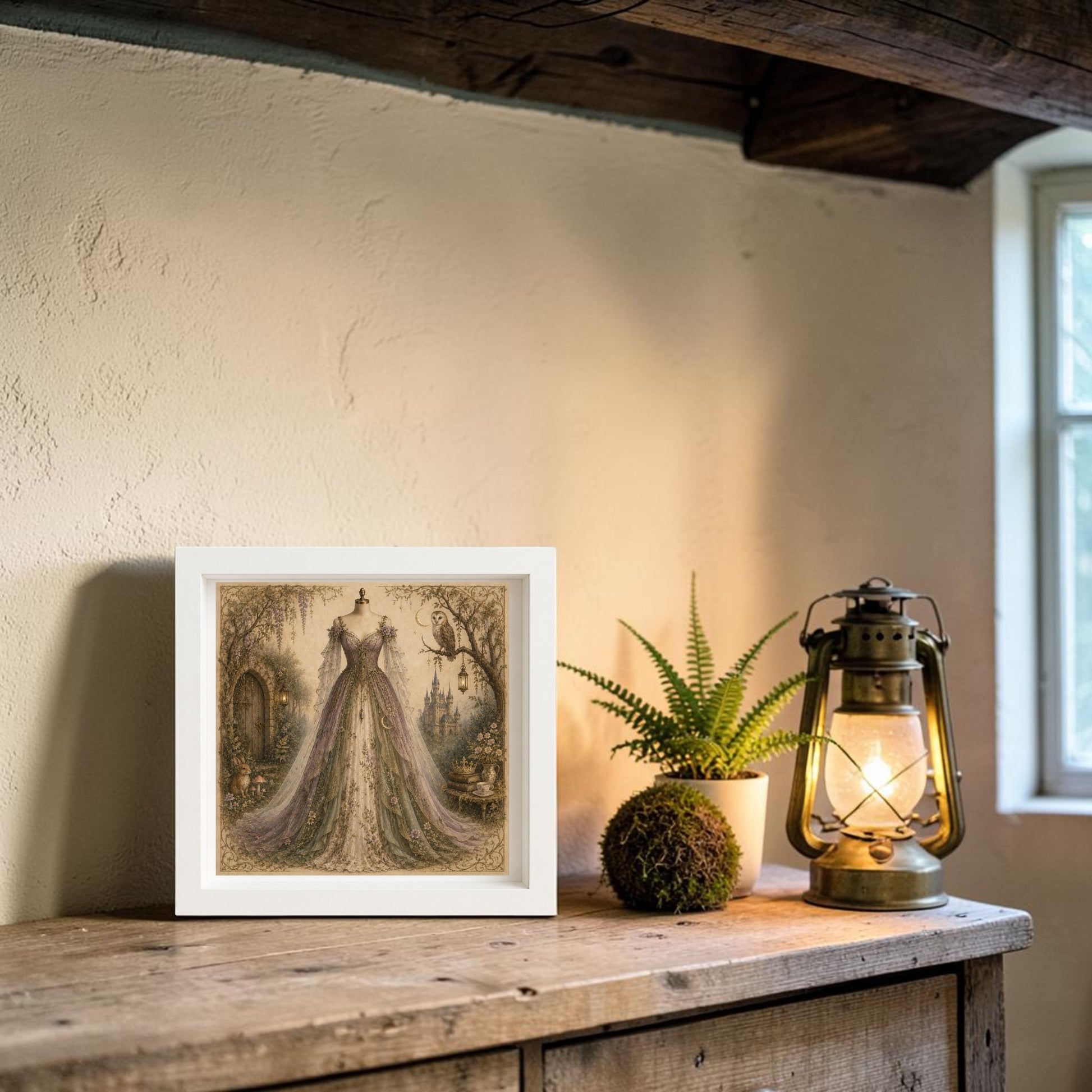 A framed "Wisteria Dreams | Curated Couture Artwork" by Mirabilia Boutique rests on a wooden shelf alongside a potted plant, moss ball, and vintage lantern, beneath a rustic beam near a window—evoking the charm of an enchanted hollow.