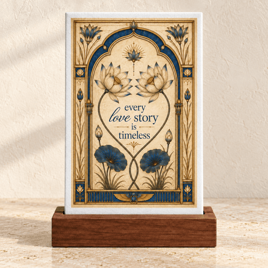 An Every Love Story Is Timeless | Lotus Mini Sign featuring a rectangular sign in a wooden stand with an Art Nouveau-inspired lotus decor frame and the text “every love story is timeless.”