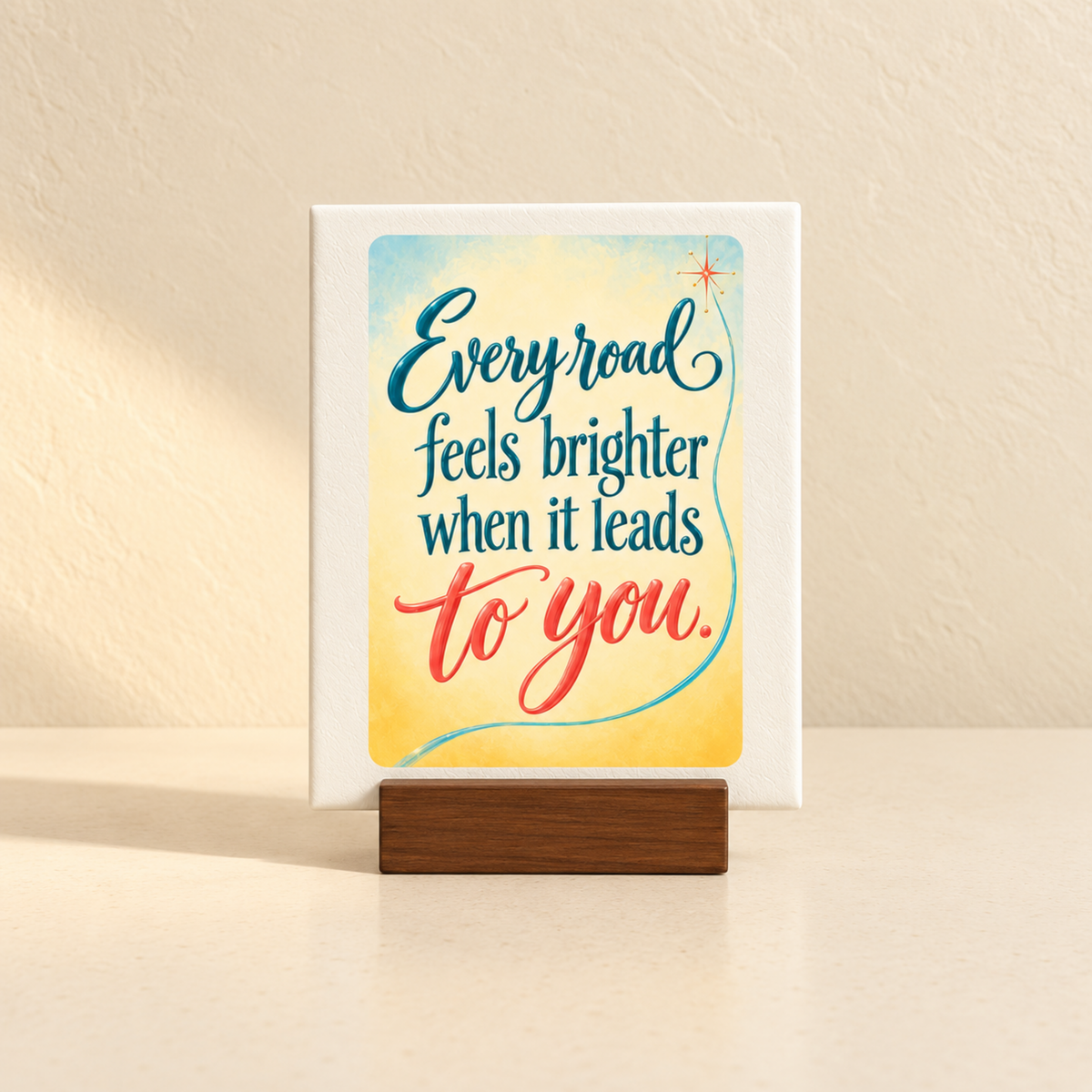 Every Road Feels Brighter Mini Sign | Chrome & Starlight featuring a mini canvas sign in a wooden base that reads, “Every road feels brighter when it leads to you.”.