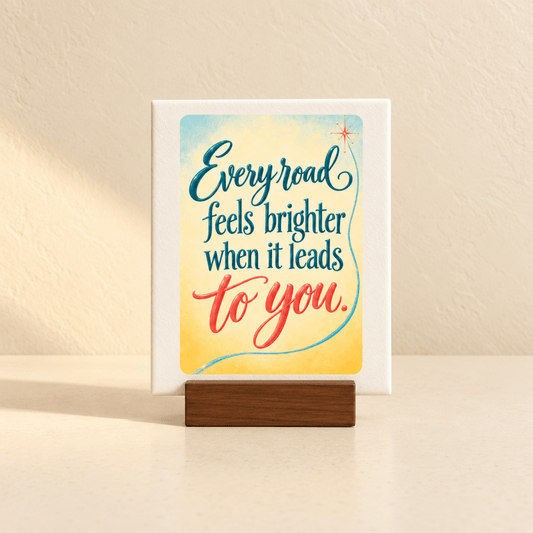 Every Road Feels Brighter Mini Sign | Chrome & Starlight featuring a mini canvas sign in a wooden base that reads, “Every road feels brighter when it leads to you.”.