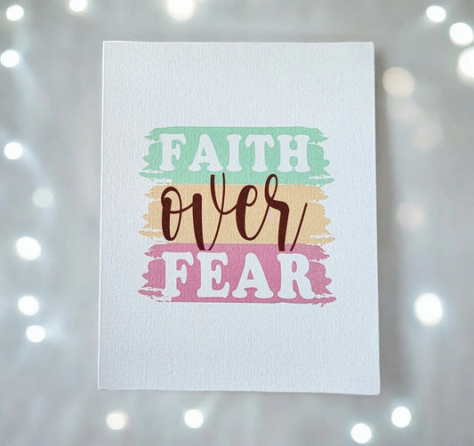 Presenting the "Faith Over Fear" Canvas Art by Mirabilia Boutique, a piece of inspirational wall decor for your home. This motivational artwork showcases "Faith Over Fear" prominently on a pastel-themed background with teal, peach, and pink paint-like stripes. The canvas features softly blurred effects complemented by glowing lights to provide an inspiring touch.